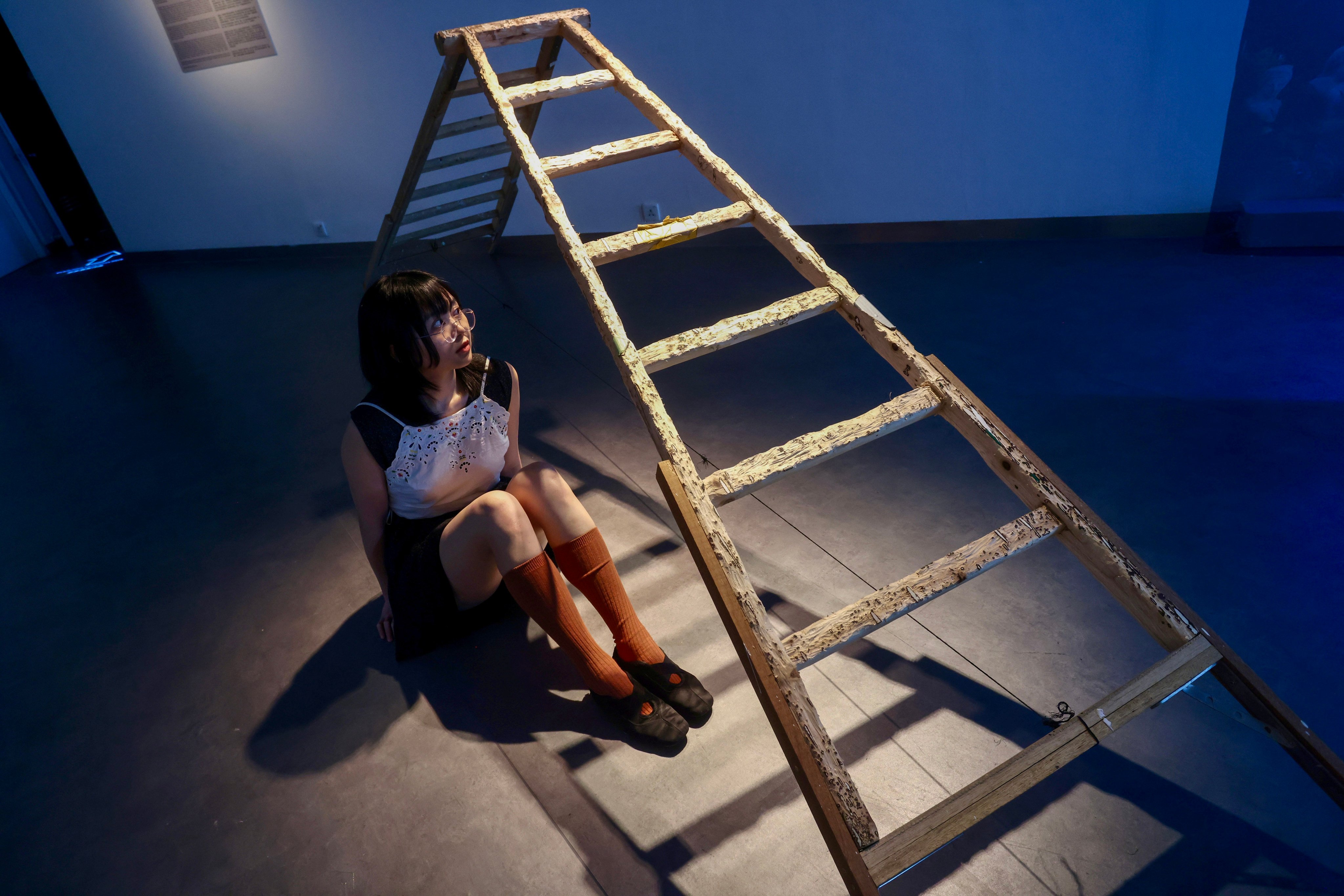 Artist Bethany Man sits next to her work Retired A-frame at the “Free Radicals” art exhibition at the Goethe Gallery and Black Box Studio at the Hong Kong Arts Centre. Photo: Jonathan Wong