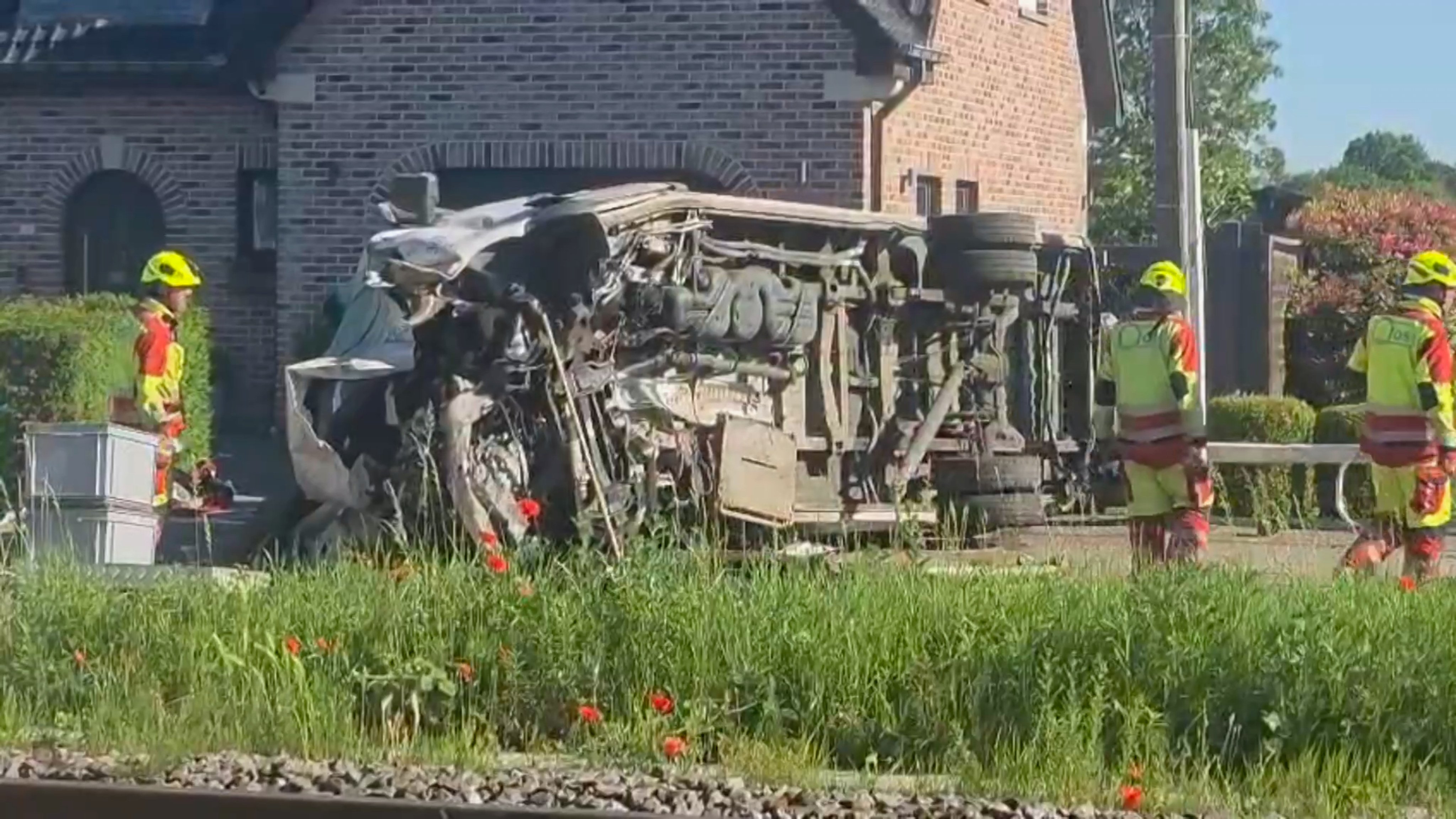 Rescuers work at the scene of a crash between a train and school bus in Buggenhout, Belgium, on Tuesday. Photo: VTM/AP