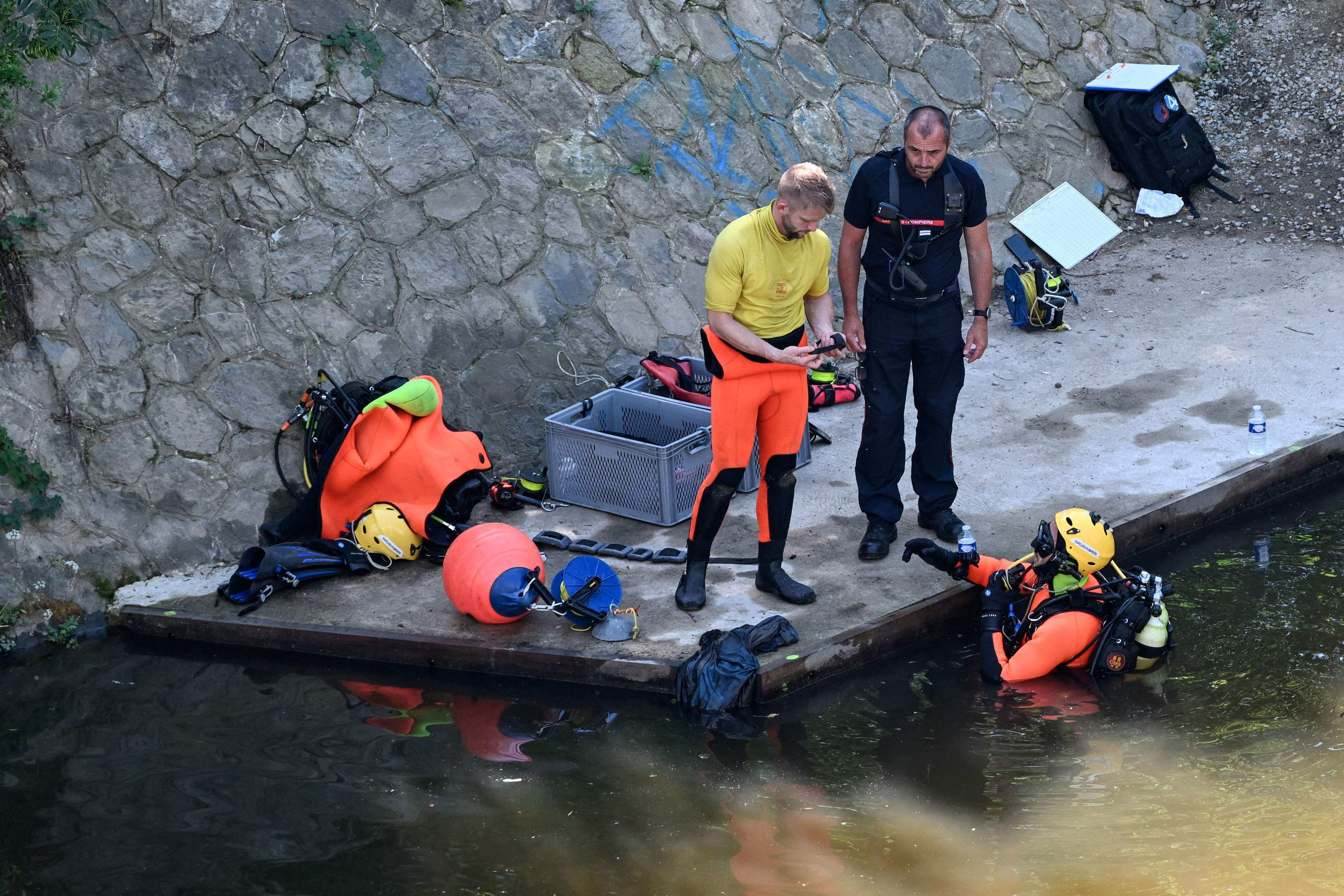 Divers search for evidence near where the body of the 11-year-old boy was found. Photo: AFP