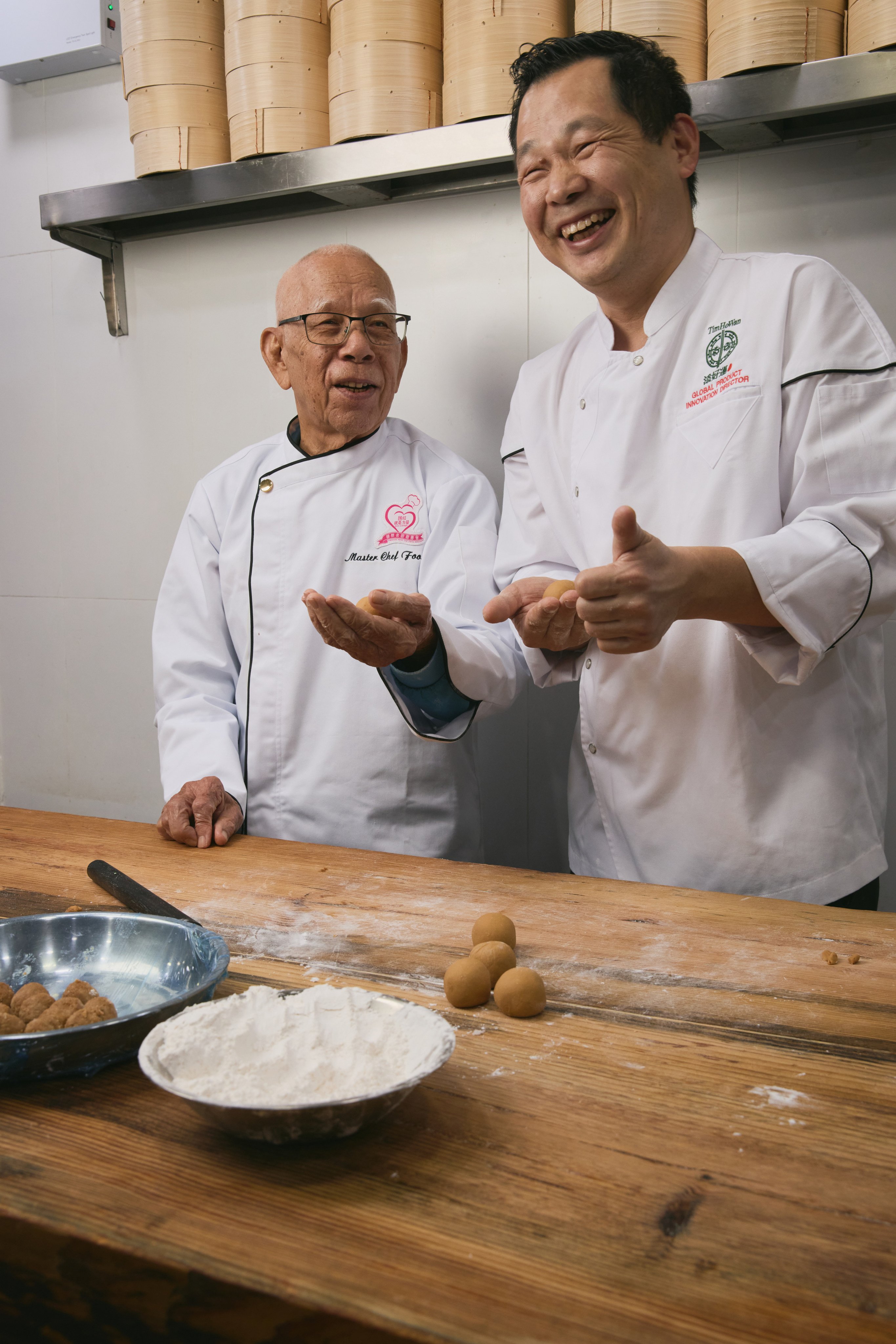 Dim sum chef Foo Shing (left) shares a laugh with Cheung Yat-sing, global product innovation director at Tim Ho Wan. The Hong Kong dim sum restaurant chain has launched a nostalgic dim sum series based on Foo’s recipes. Photo: Tim Ho Wan