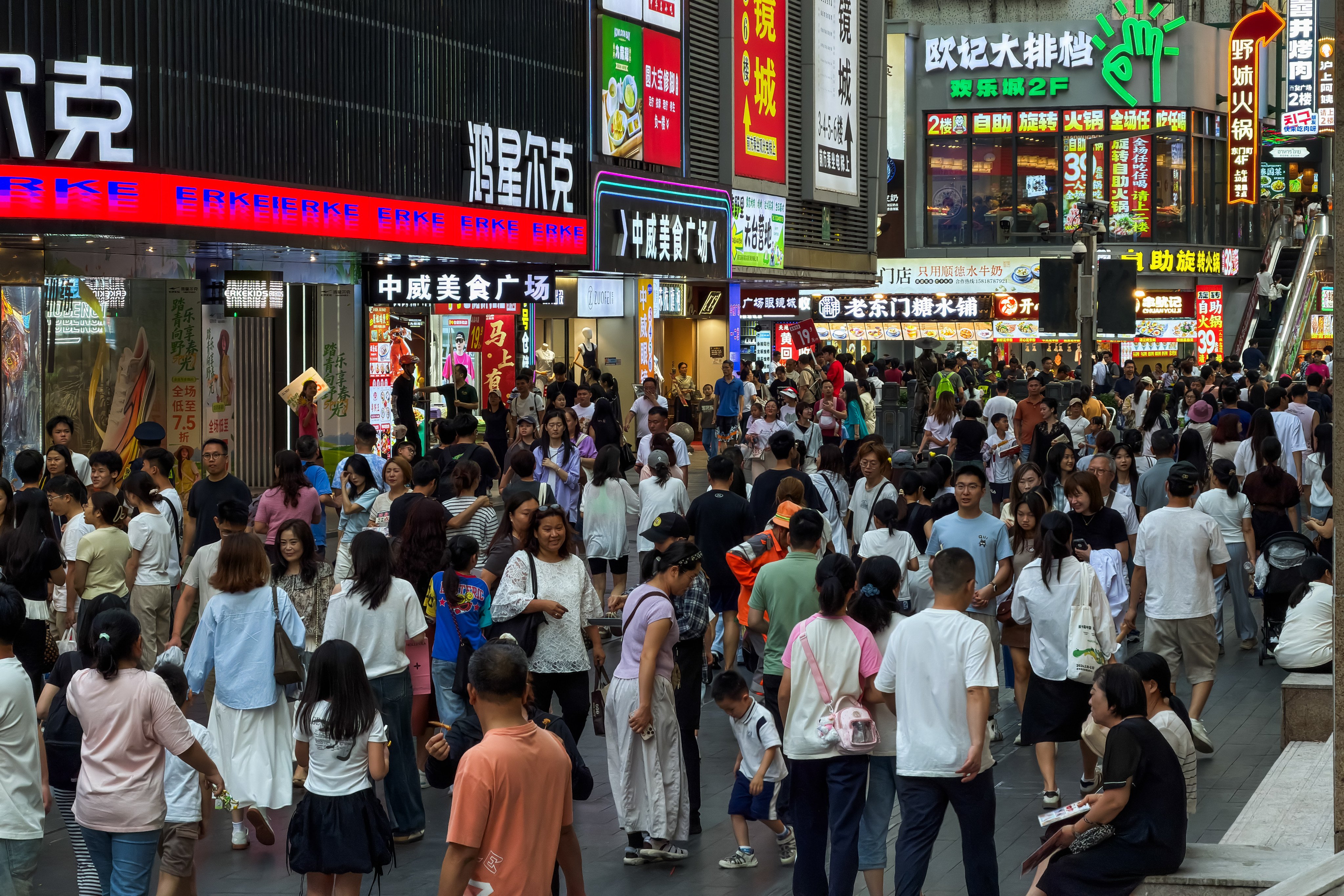Crowds of pedestrians walk along a busy commercial street in Shenzhen’s Dongmen area on April 18. Photo: Getty Images