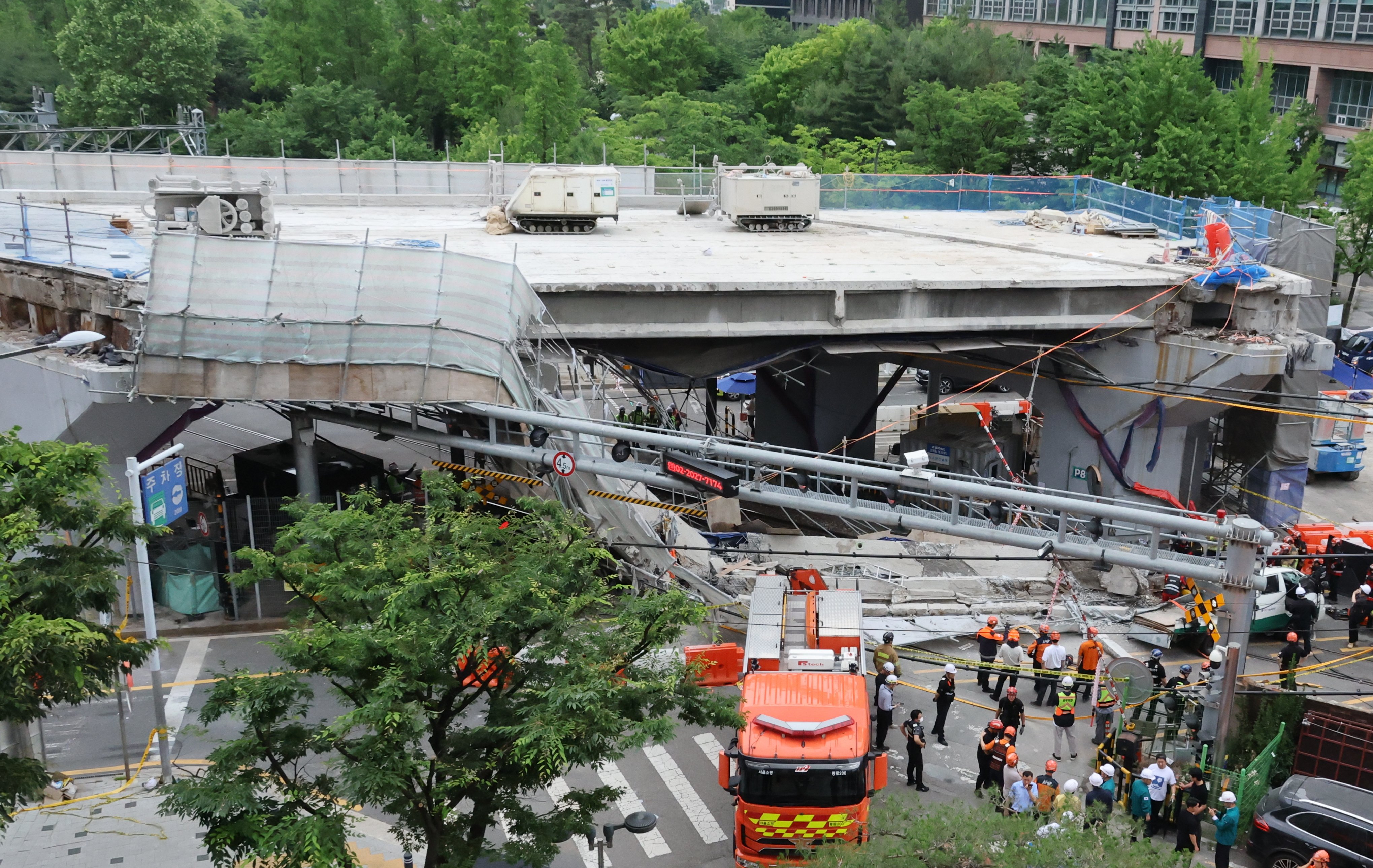 Rescuers search for victims after an overpass collapses in western Seoul on Tuesday. Photo: Yonhap/EPA