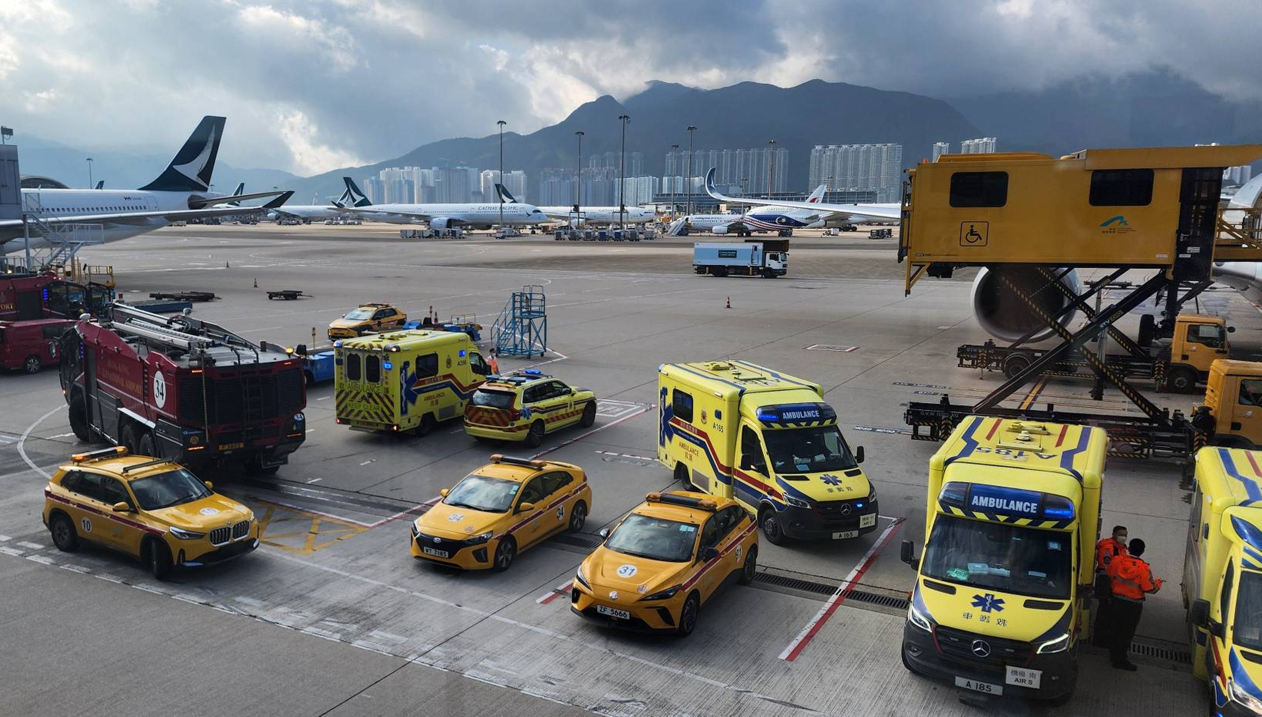 Ambulances wait at Hong Kong International Airport on Saturday morning for the Brisbane flight. Photo: Handout