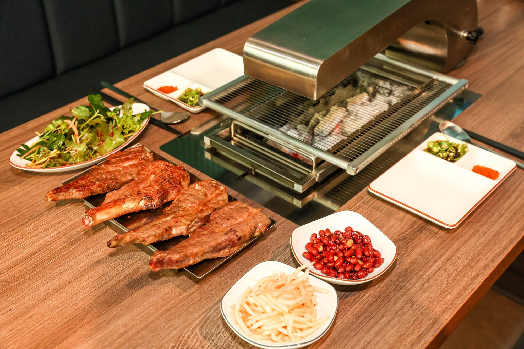 An array of dishes sits beside a barbecue grill on a restaurant table. Photo: Shutterstock An array of dishes sits beside a barbecue grill on a restaurant table. Photo: Shutterstock