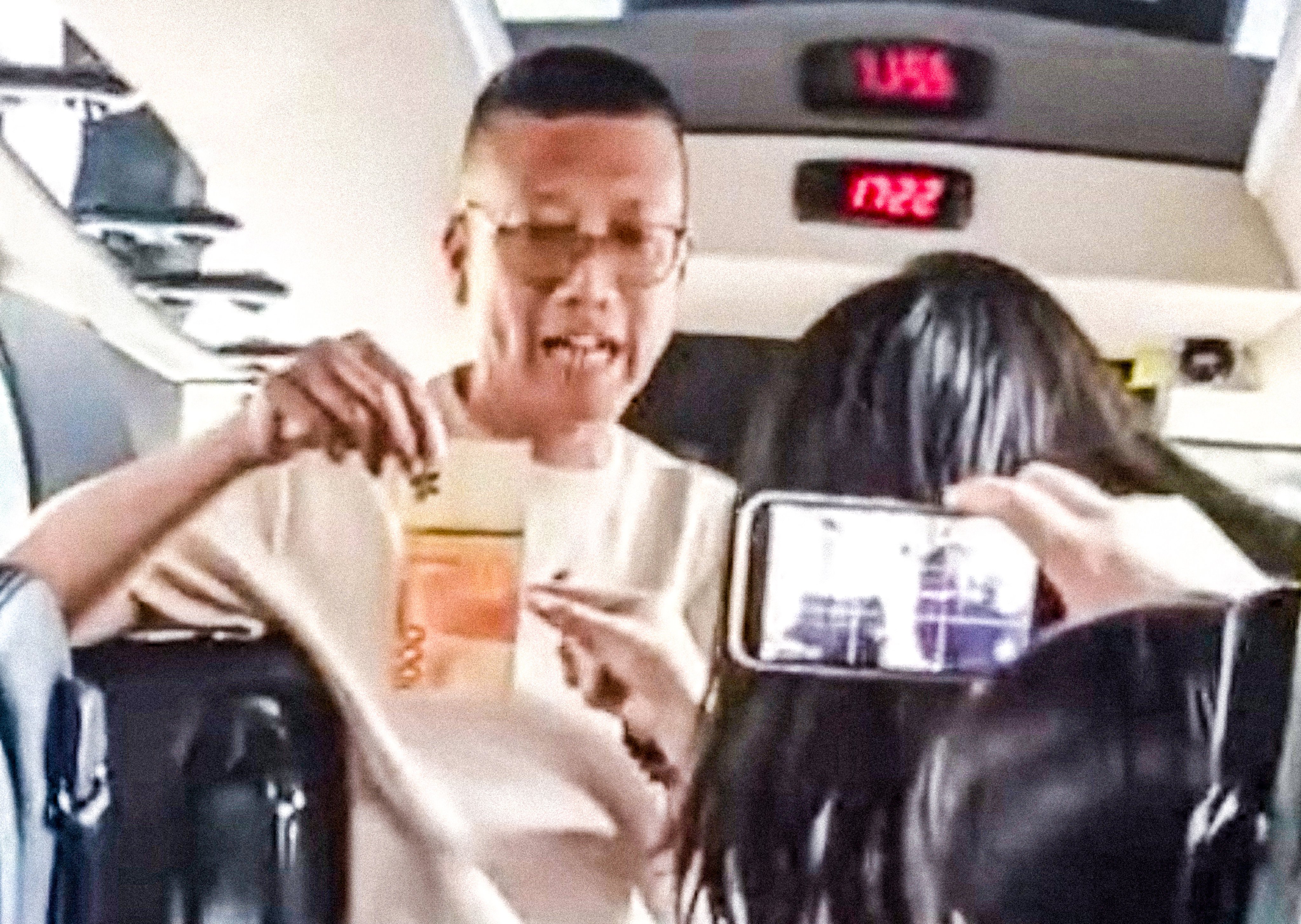 A new video went viral on Monday, showing Lee Cheuk-hing playing a controversial game with female students on a coach bus. Photo: Handout