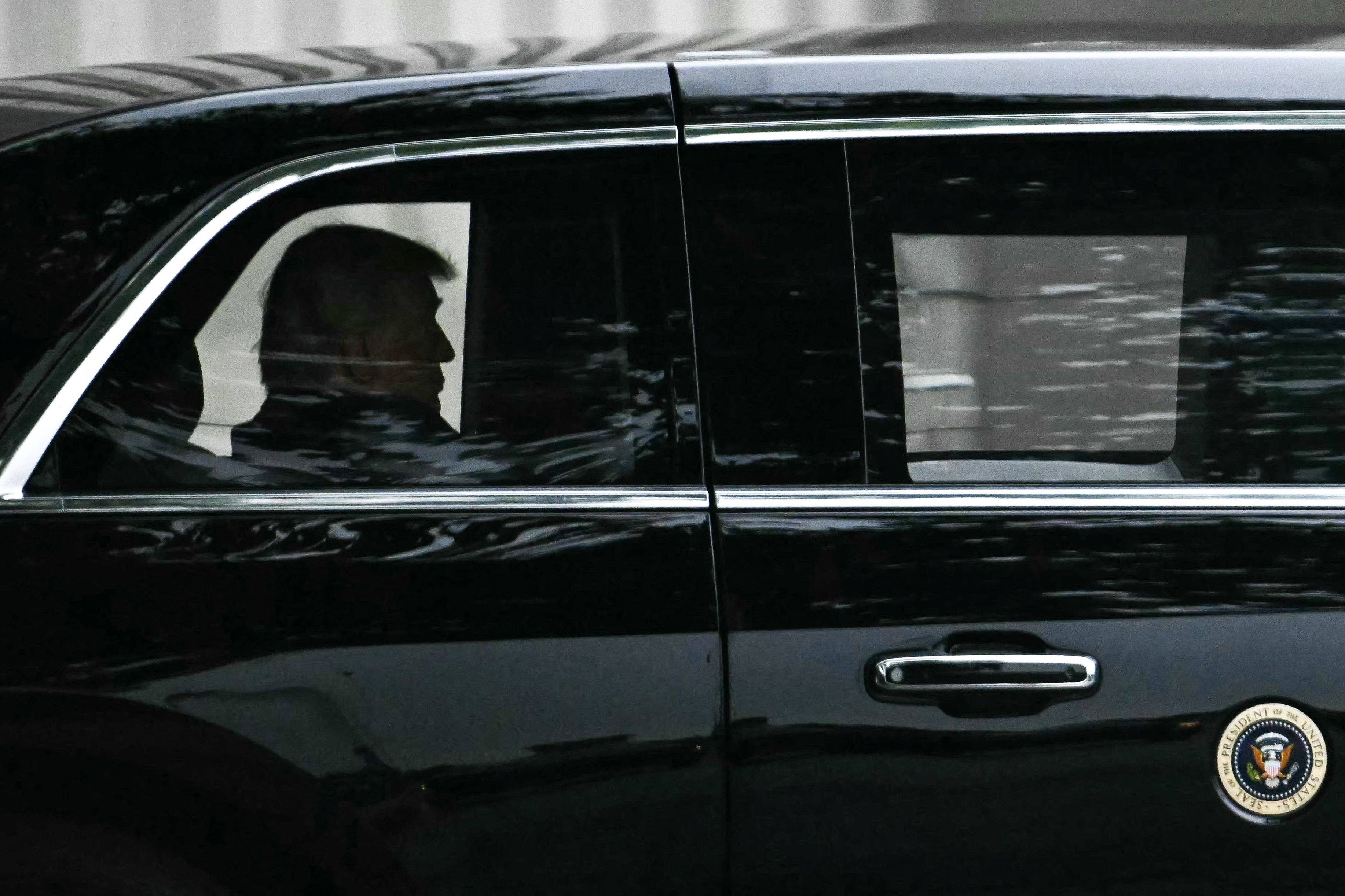 US President Donald Trump rides in his motorcade as he leaves Walter Reed National Military Medical Centre on Tuesday. Photo: AFP