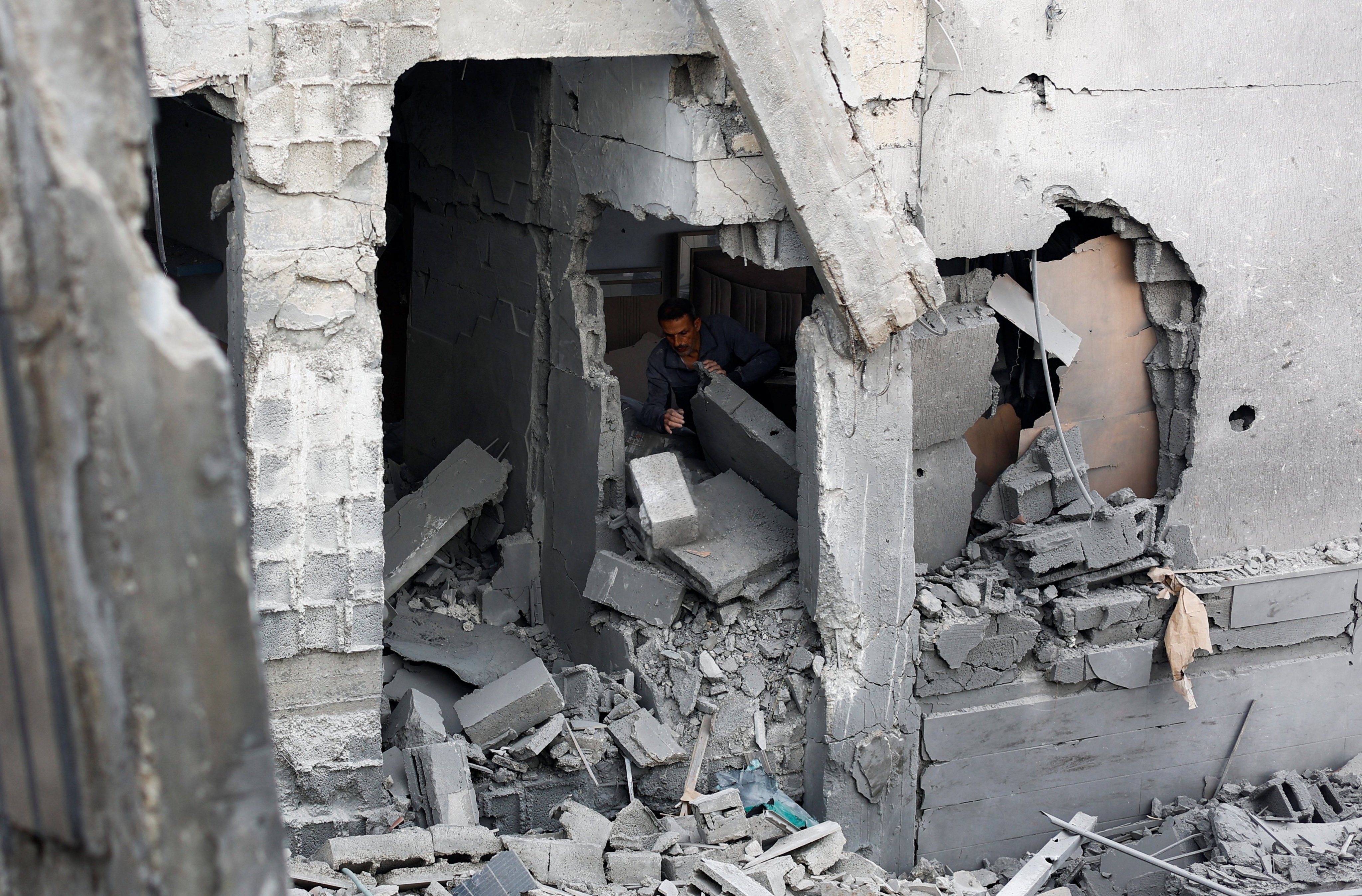 A Palestinian man inspects the site of an Israeli strike on a Gaza City residential building. Photo: Reuters