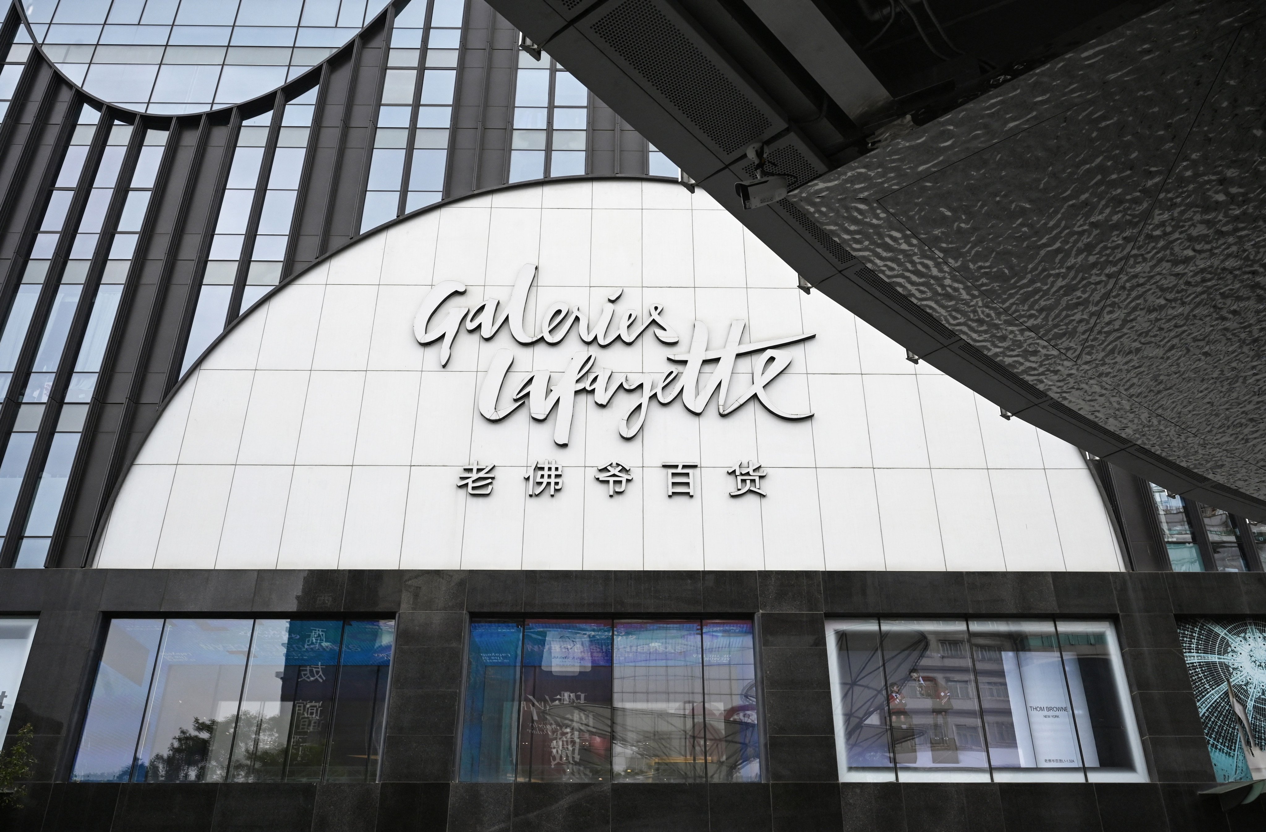 A sign is seen on the Galeries Lafayette mall, a day before it closes, in Beijing on May 26, 2026. The closure of France’s Galeries Lafayette’s first China flagship on May 27, takes place against a backdrop of a sluggish post-pandemic economy and shifting consumption practices. (Photo by GREG BAKER / AFP) / TO GO WITH: China-luxury-retail-economy-consumption, FOCUS by Mary YANG and Agatha CANTRILL in Shanghai