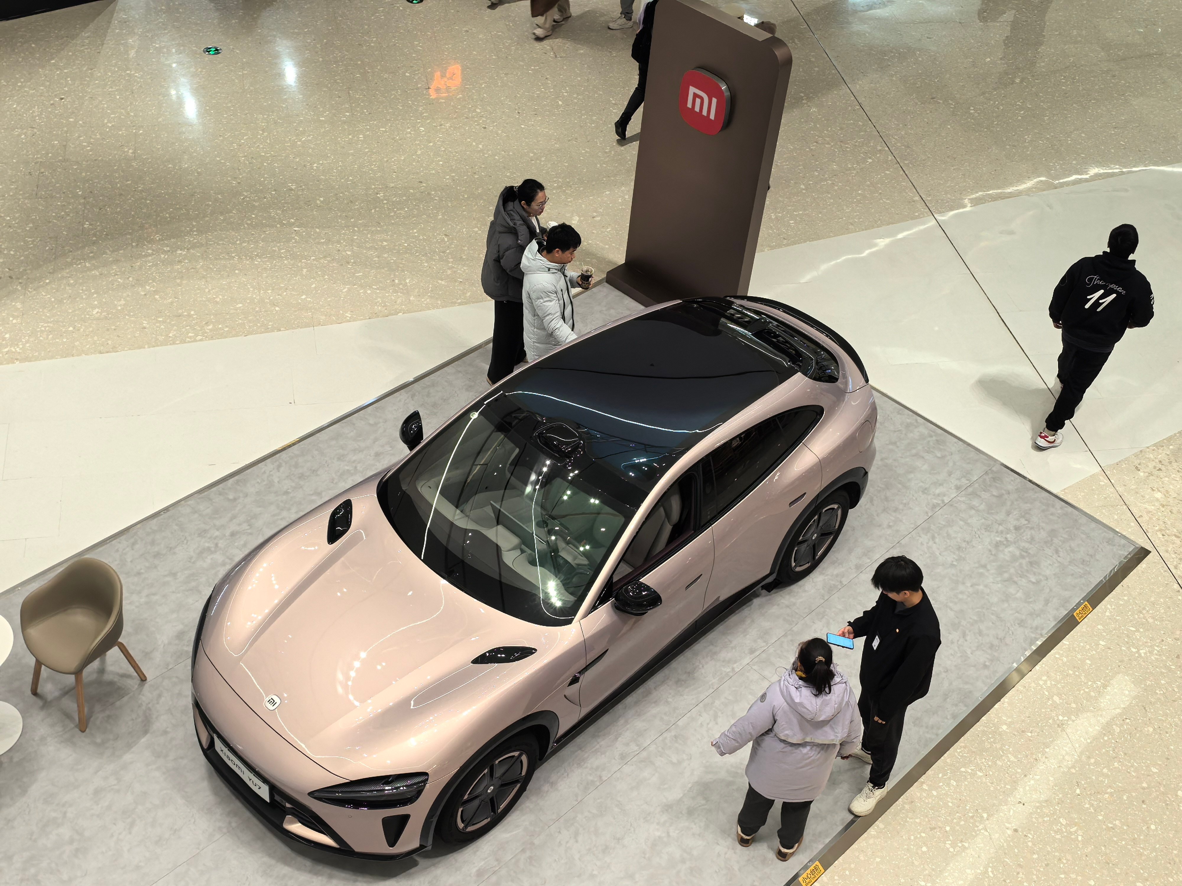 People check the Xiaomi YU7 new energy (EV) car in a new shopping mall in Beijing. Photo: Simon Song