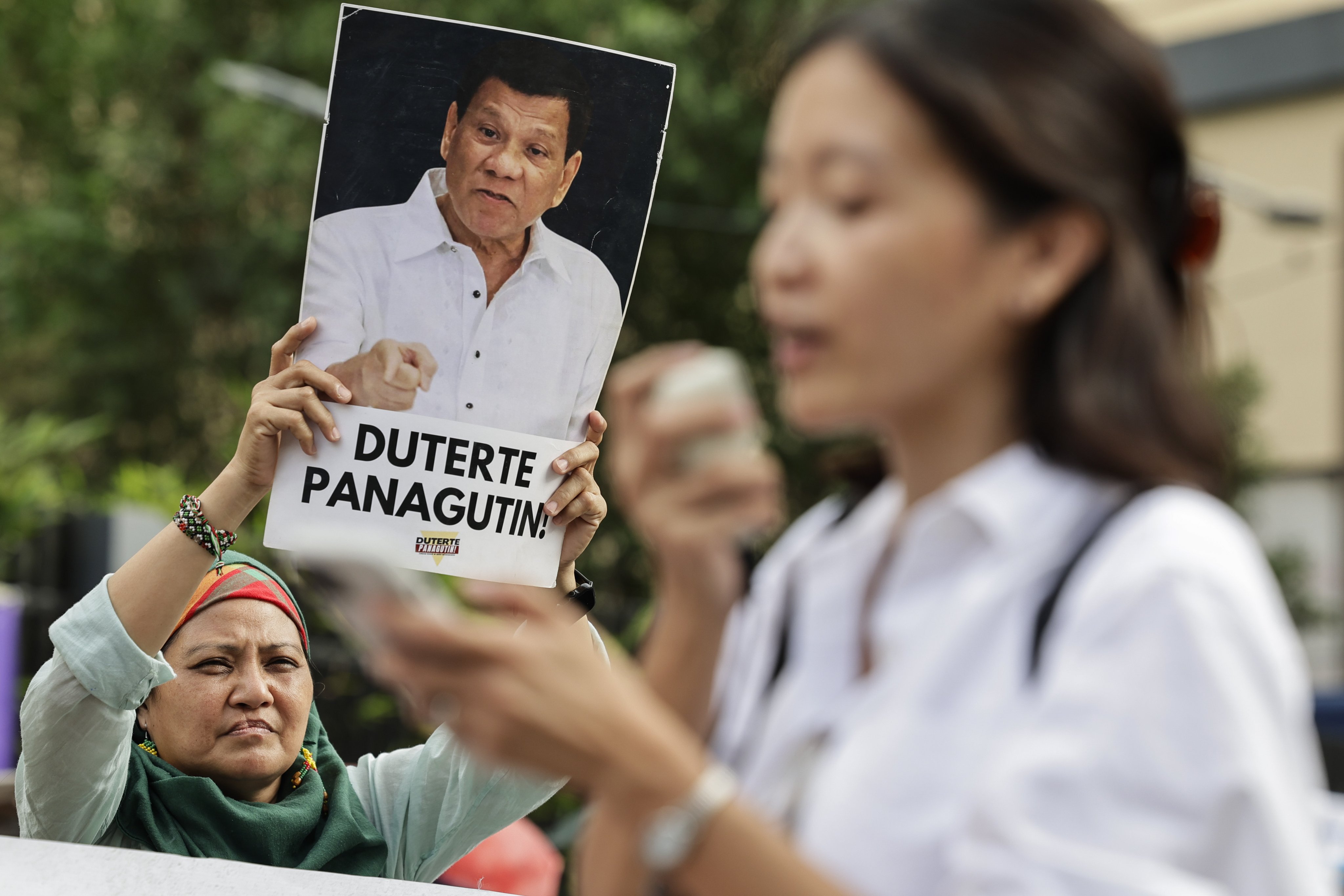 A protester holds an image of former Philippine president Rodrigo Duterte with a message reading, “Hold Duterte Accountable!”, during a rally in Quezon City, Metro Manila, Philippines in March. Photo: EPA