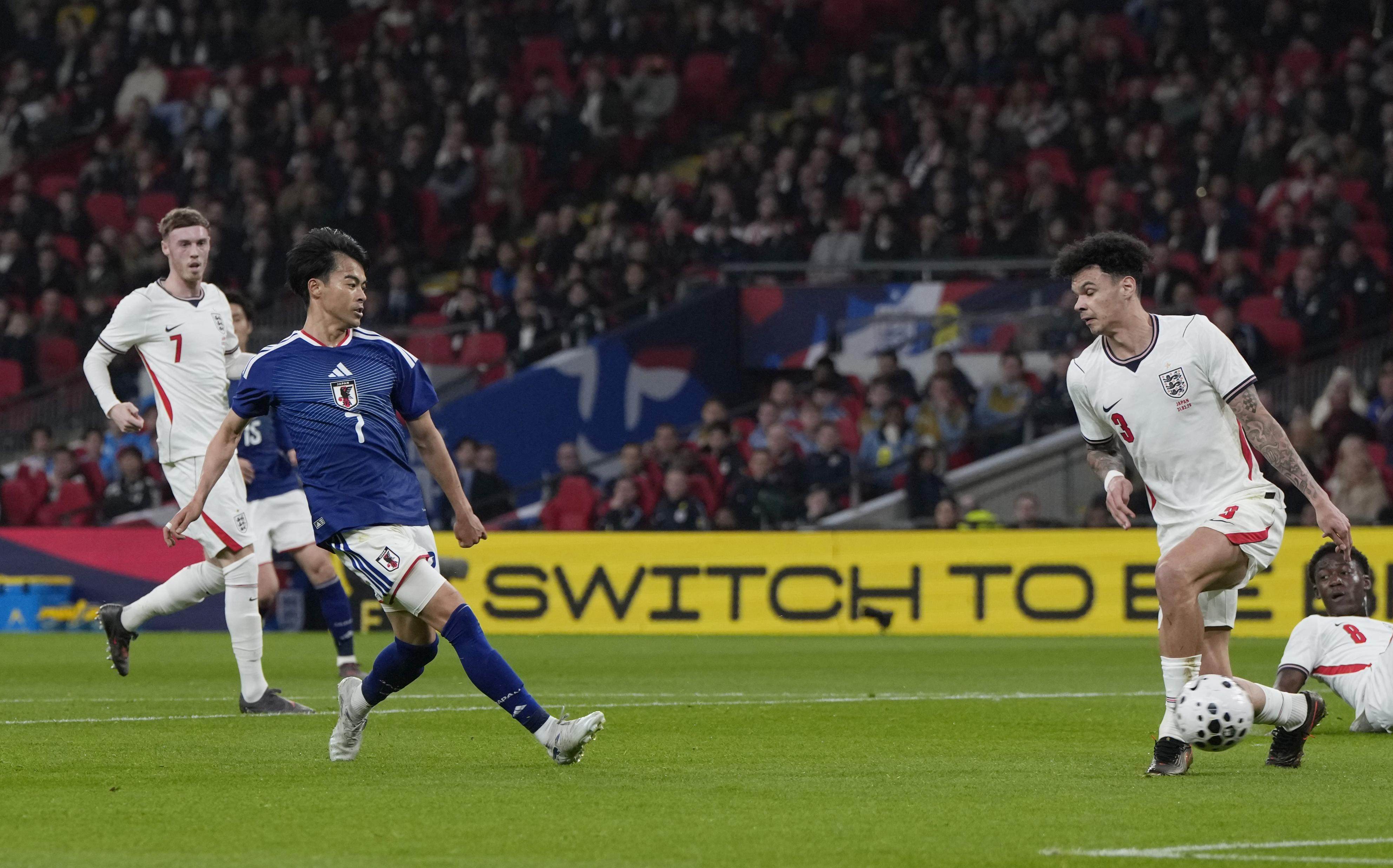 Japan’s Kaoru Mitoma (front left) scores during an international friendly against England at Wembley Stadium in March. Photo: Kyodo