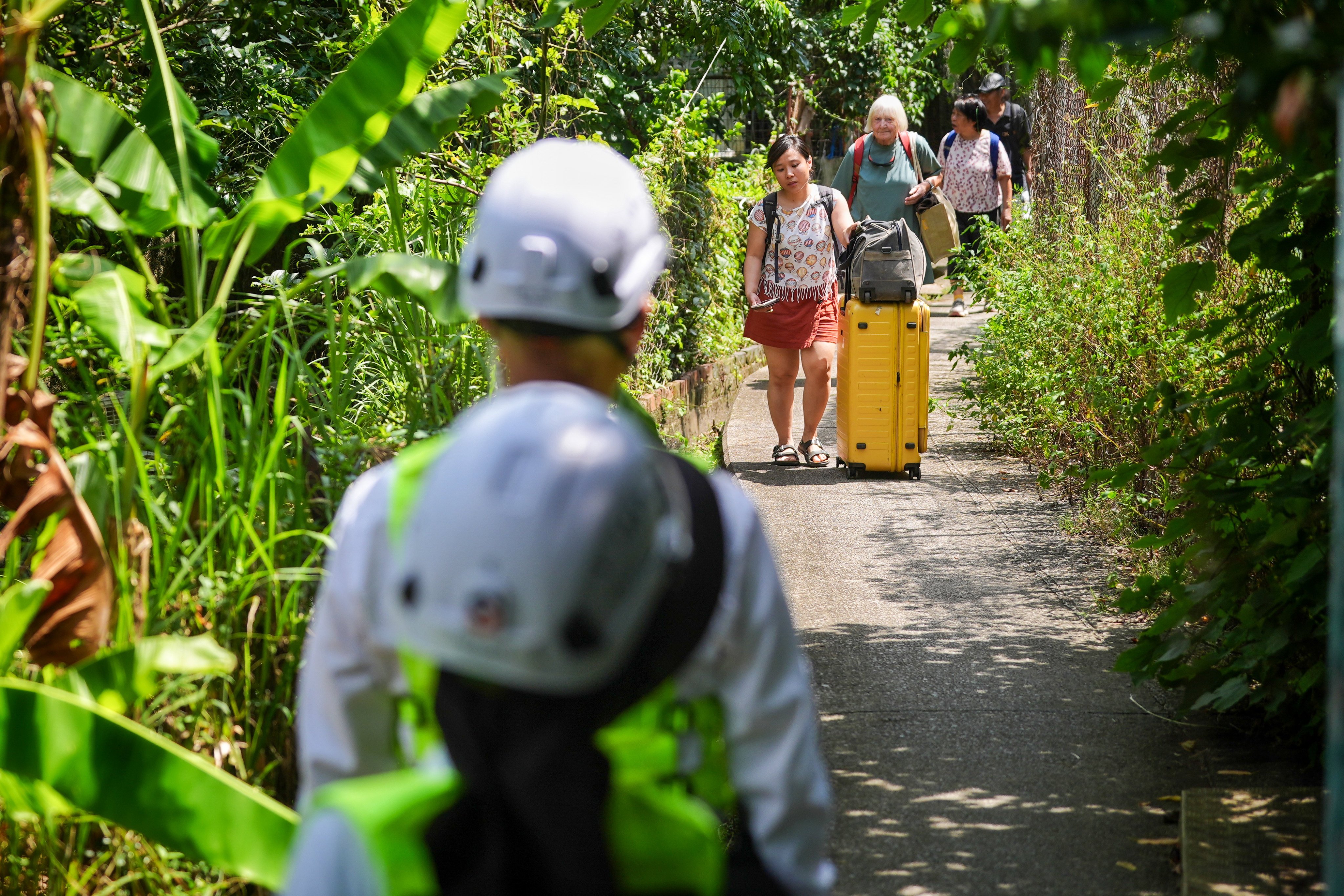 The Li family and friends leave their village in Tuen Mun on Wednesday. Photo: Elson Li