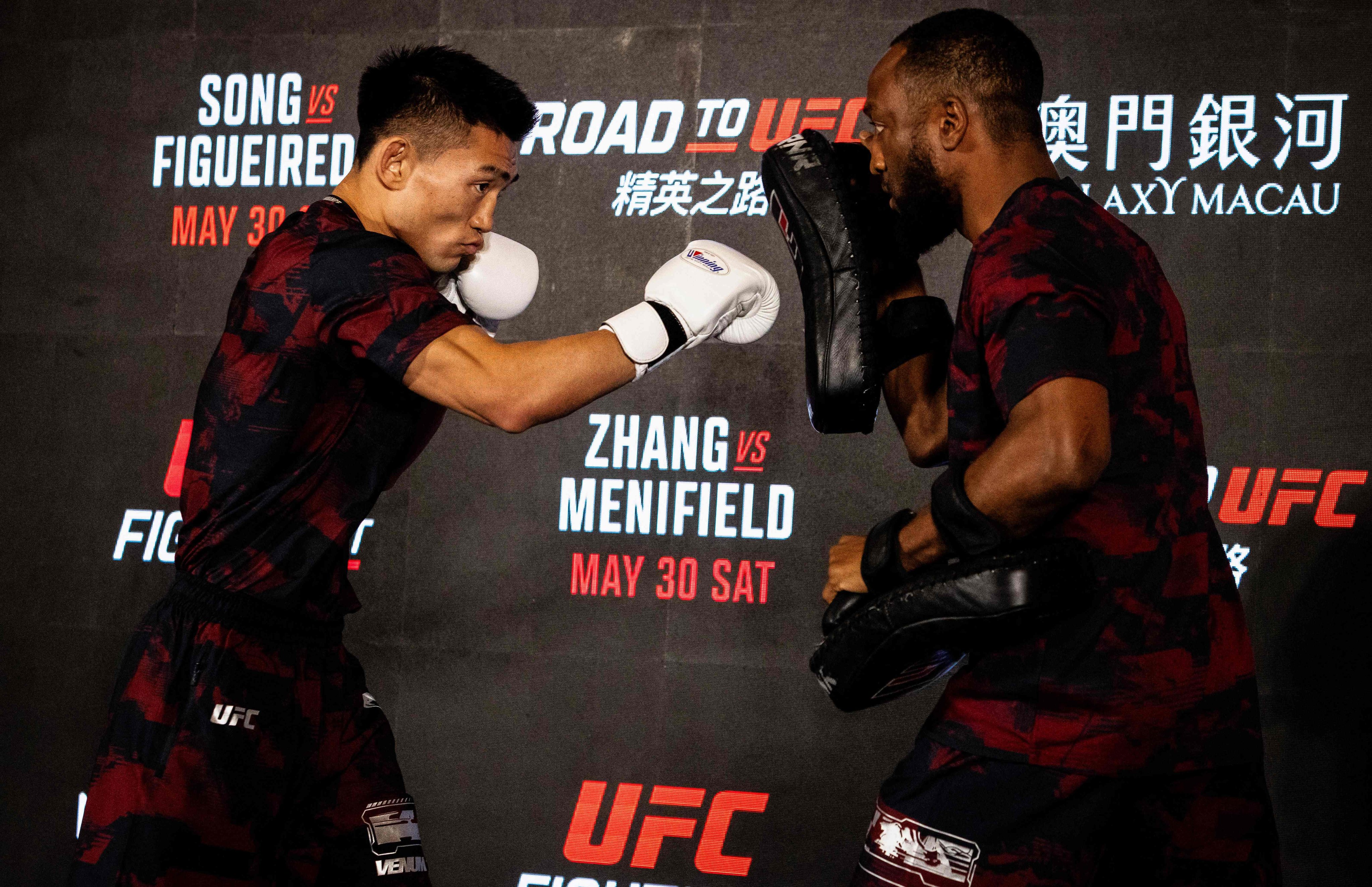 Chinese fighter Song Yadong (left) taking part in a workout session at the opening ceremony of UFC Fight Night at Macau's Galaxy resort on Wednesday. Photo: AFP