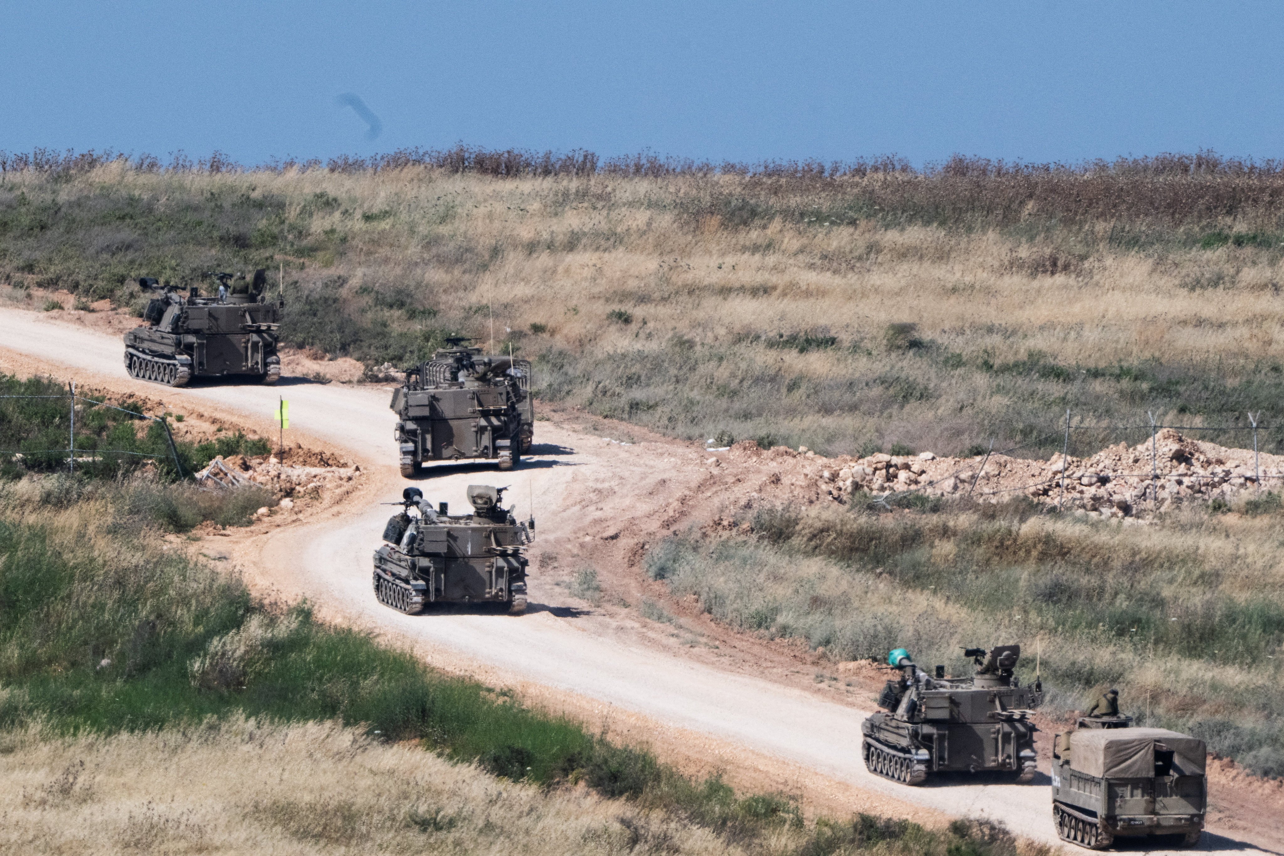 An Israeli military artillery unit drives into Lebanon after crossing the Israeli‑Lebanese border. Photo: Reuters