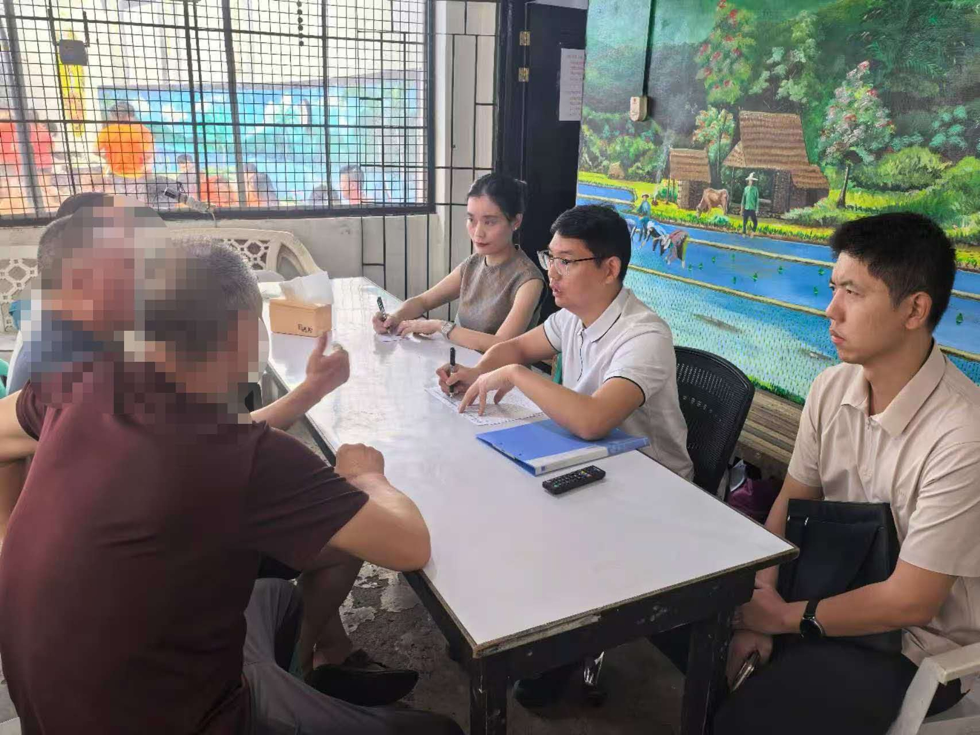 Chinese embassy personnel pay a consular visit to nationals held at a Philippine detention centre on May 18. Photo: Chinese embassy in the Philippines