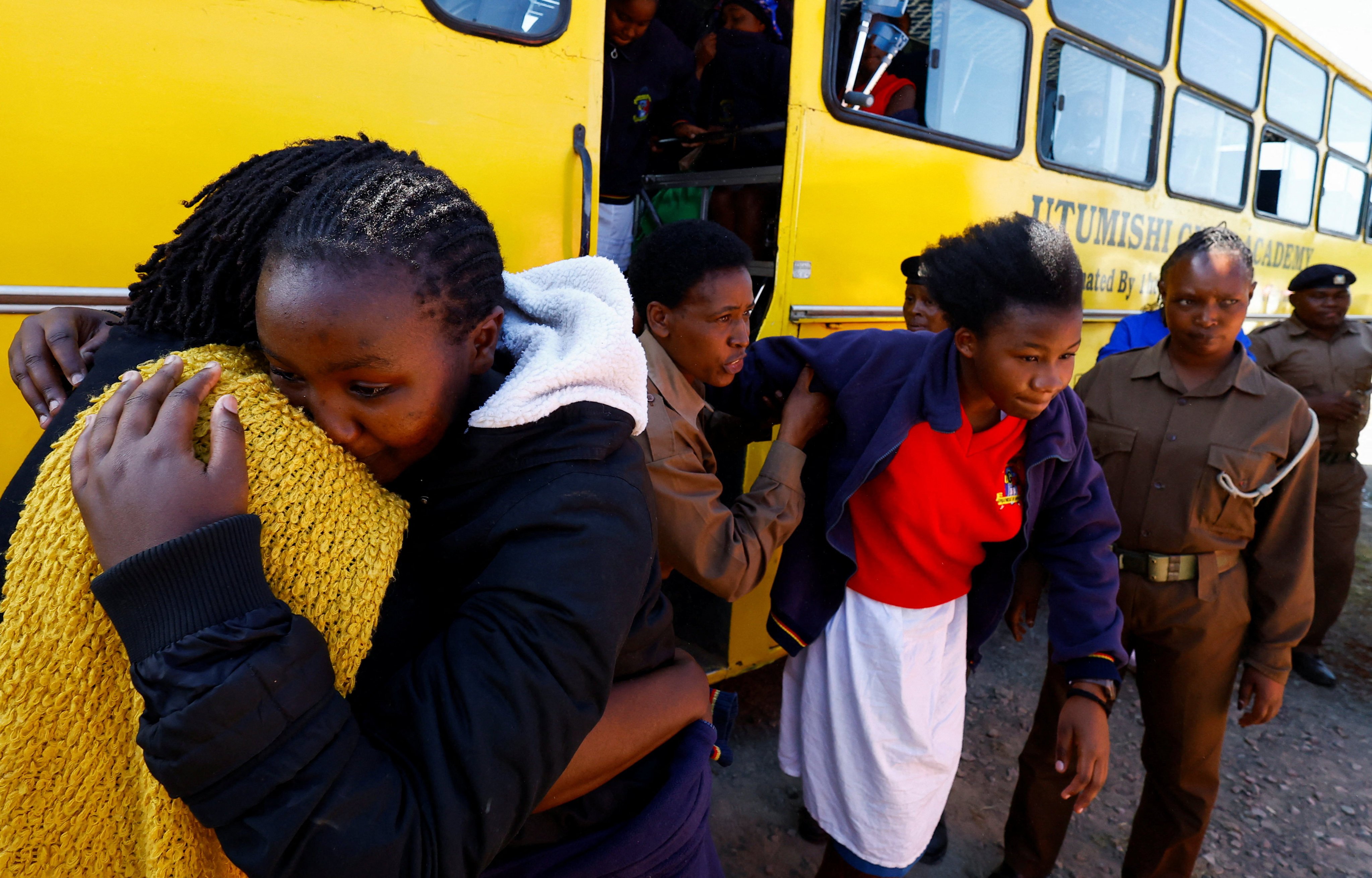 A pupil injured in a stampede is helped from a school bus at the Utumishi Girls’ Academy Senior School following an overnight fire in a dormitory at the facility in Gilgil, Nakuru county, Kenya on Thursday. Photo: Reuters