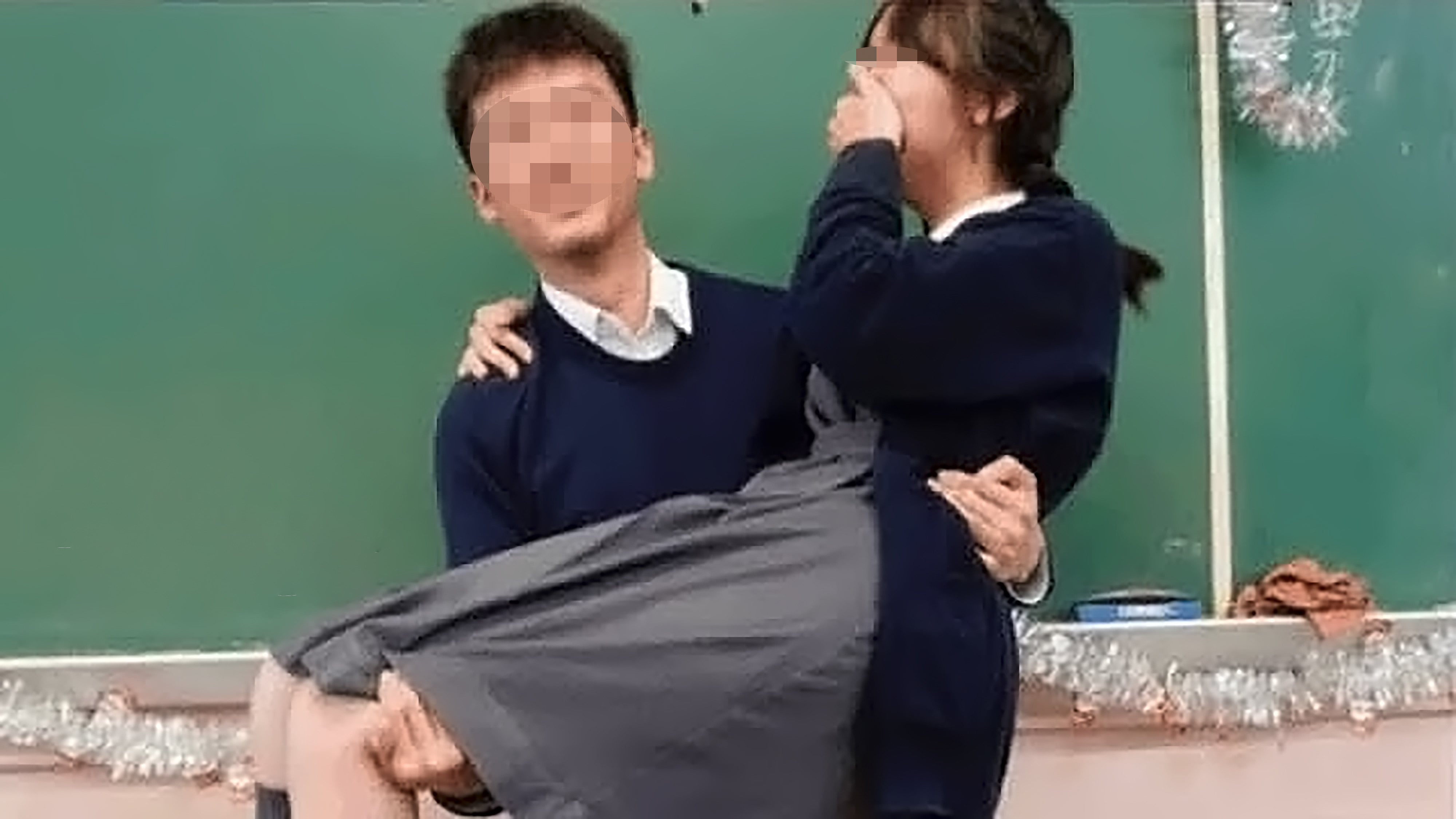 The photo circulating online showing a teacher carrying a female student in his arms. Photo: Threads