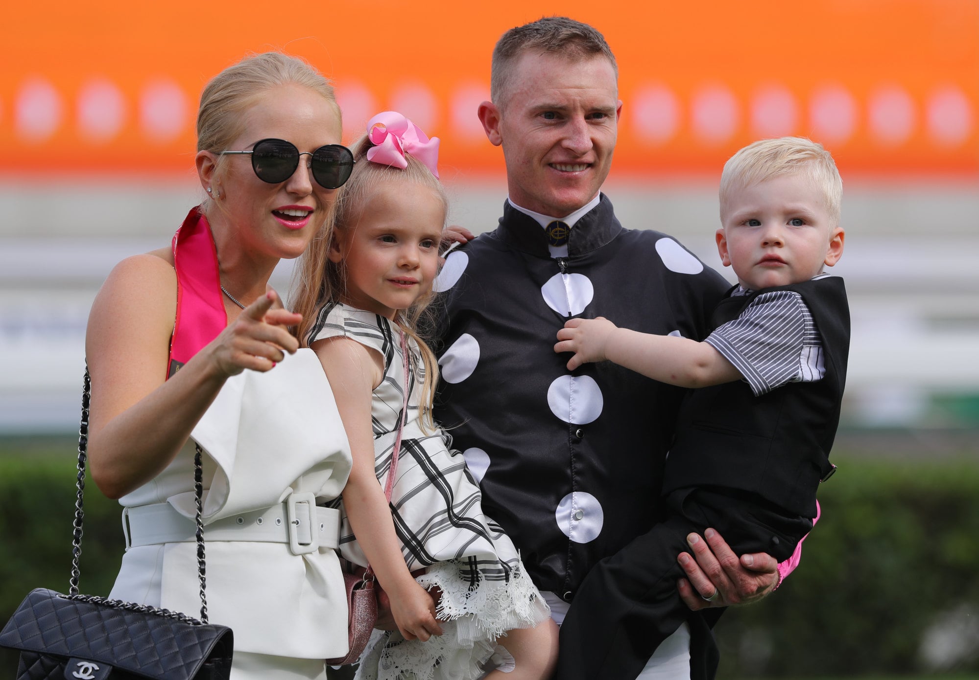 Zac Purton celebrating his victory on Beauty Generation in the Champions Mile in 2019 with Nicole, daughter Roxy and son Cash. Photo: Kenneth Chan
