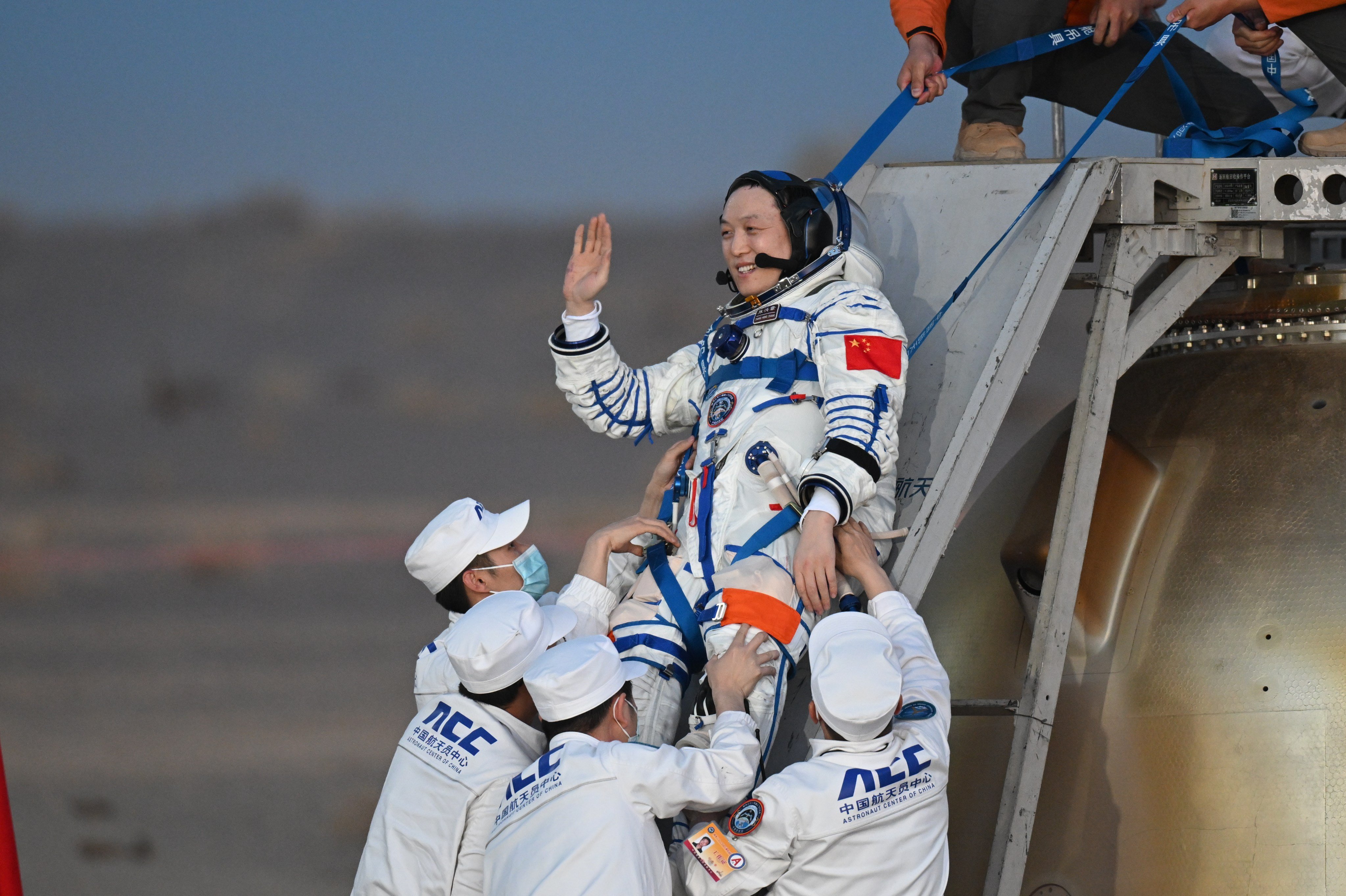 One of the astronauts exits the Shenzhou-22 spaceship’s return capsule after it touched down at the Dongfeng landing site on May 29. Photo: Xinhua