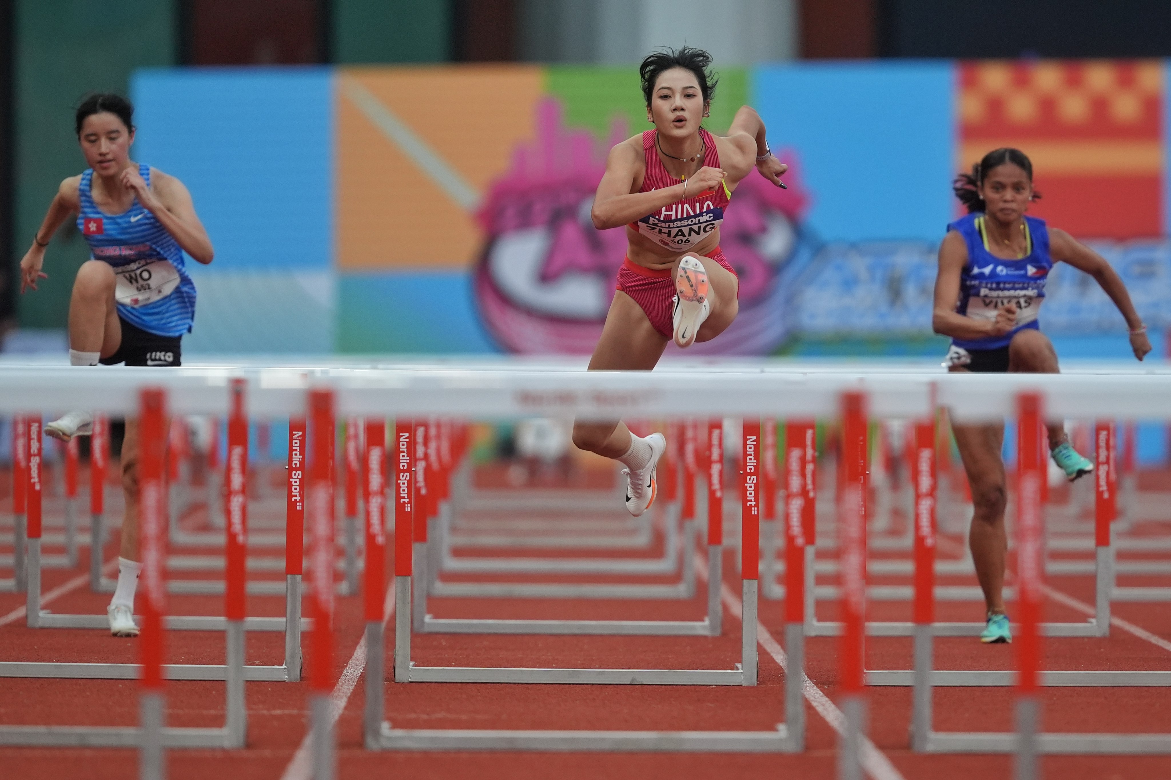 China’s Zhang Keyi (middle) winning the 100m hurdles final at the 22nd Asian U20 Athletics Championships at Kai Tak Youth Sports Ground on Friday. Photo: Elson Li