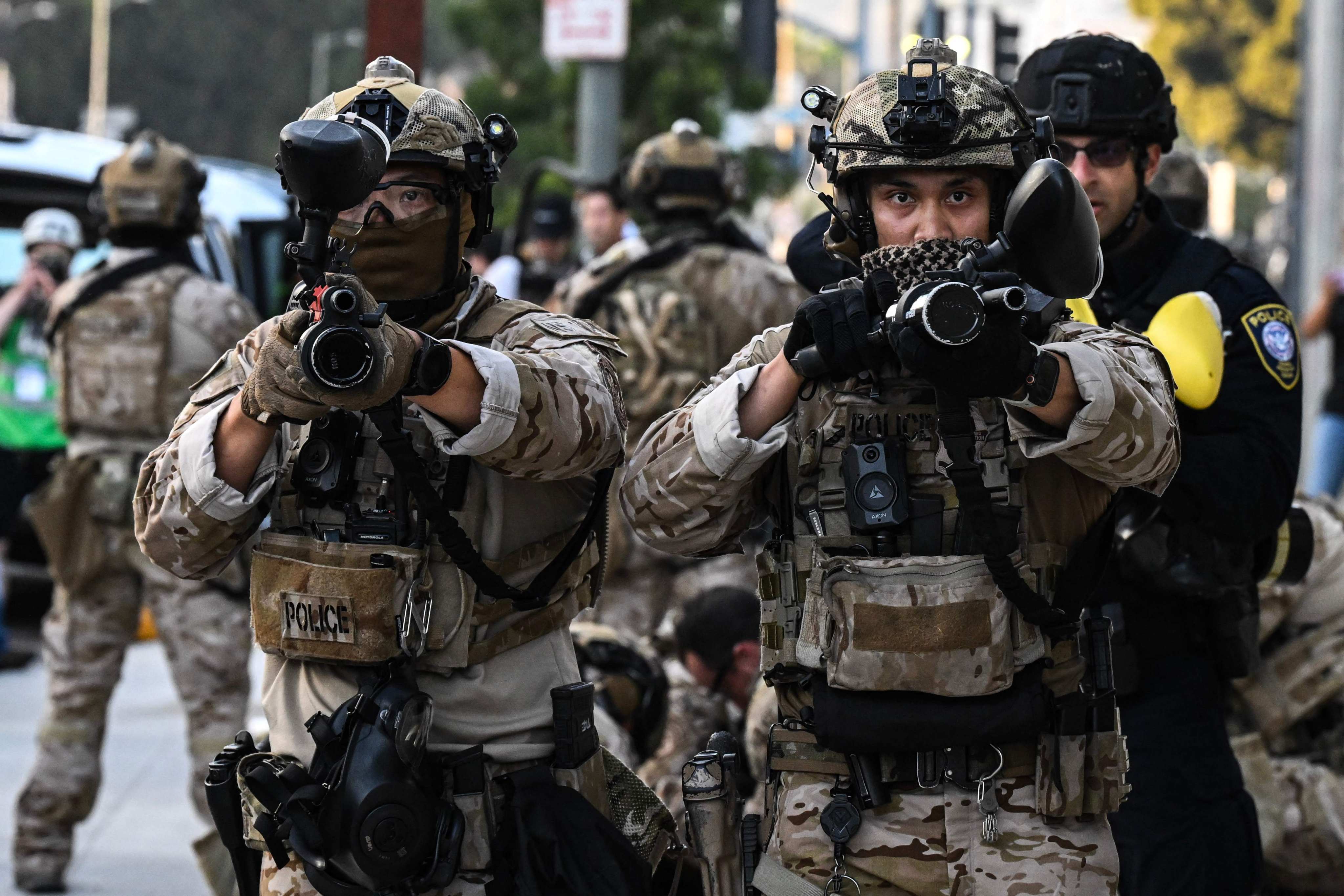 US Customs and Border Protection agents hold up less-lethal weapons in front of a federal building during a protest against the Trump administration’s immigration raids in Los Angeles last year. Photo: AFP