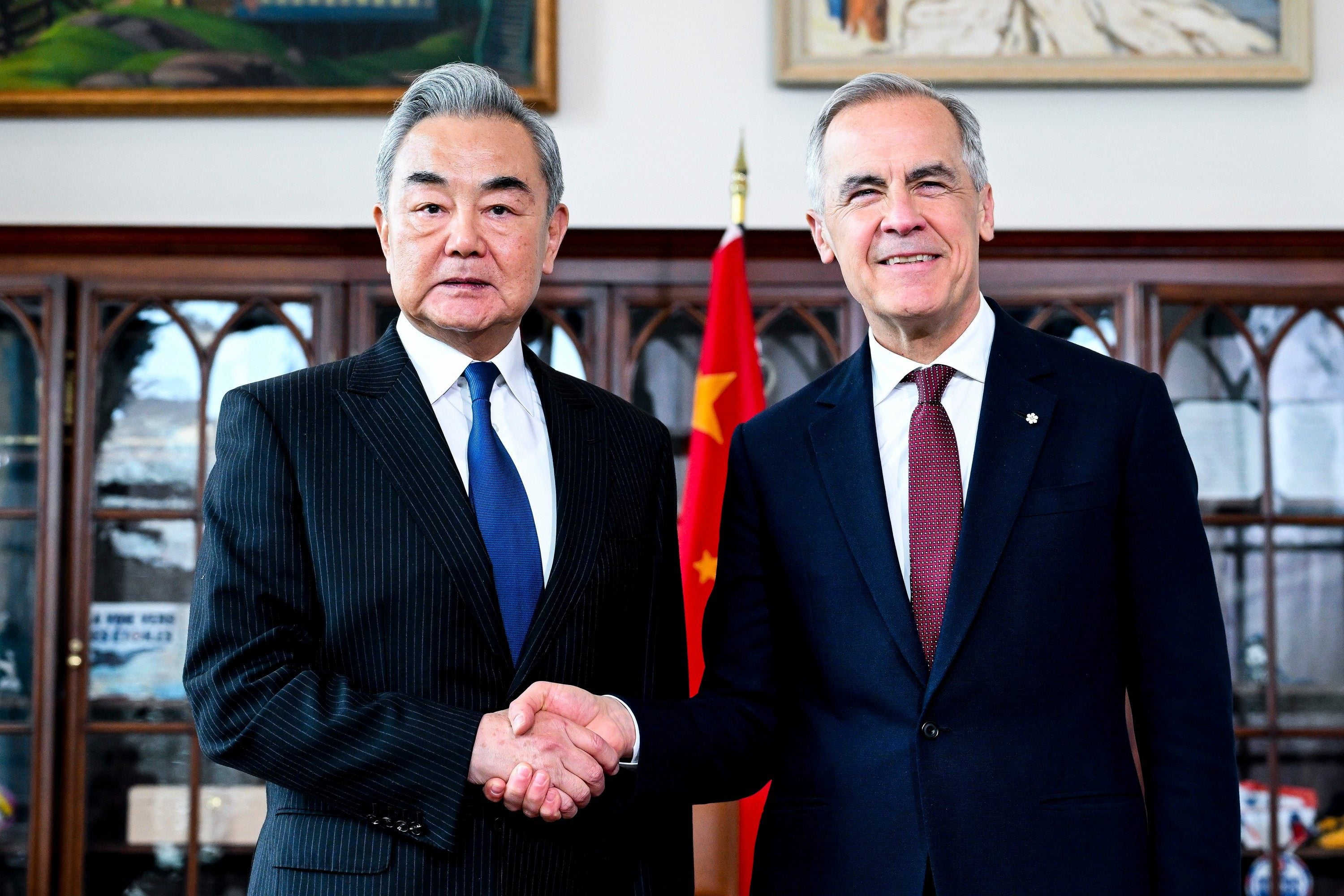 Canadian Prime Minister Mark Carney shakes hands with China’s Foreign Minister Wang Yi in his office in Ottawa on Friday. Photo: The Canadian Press via AP