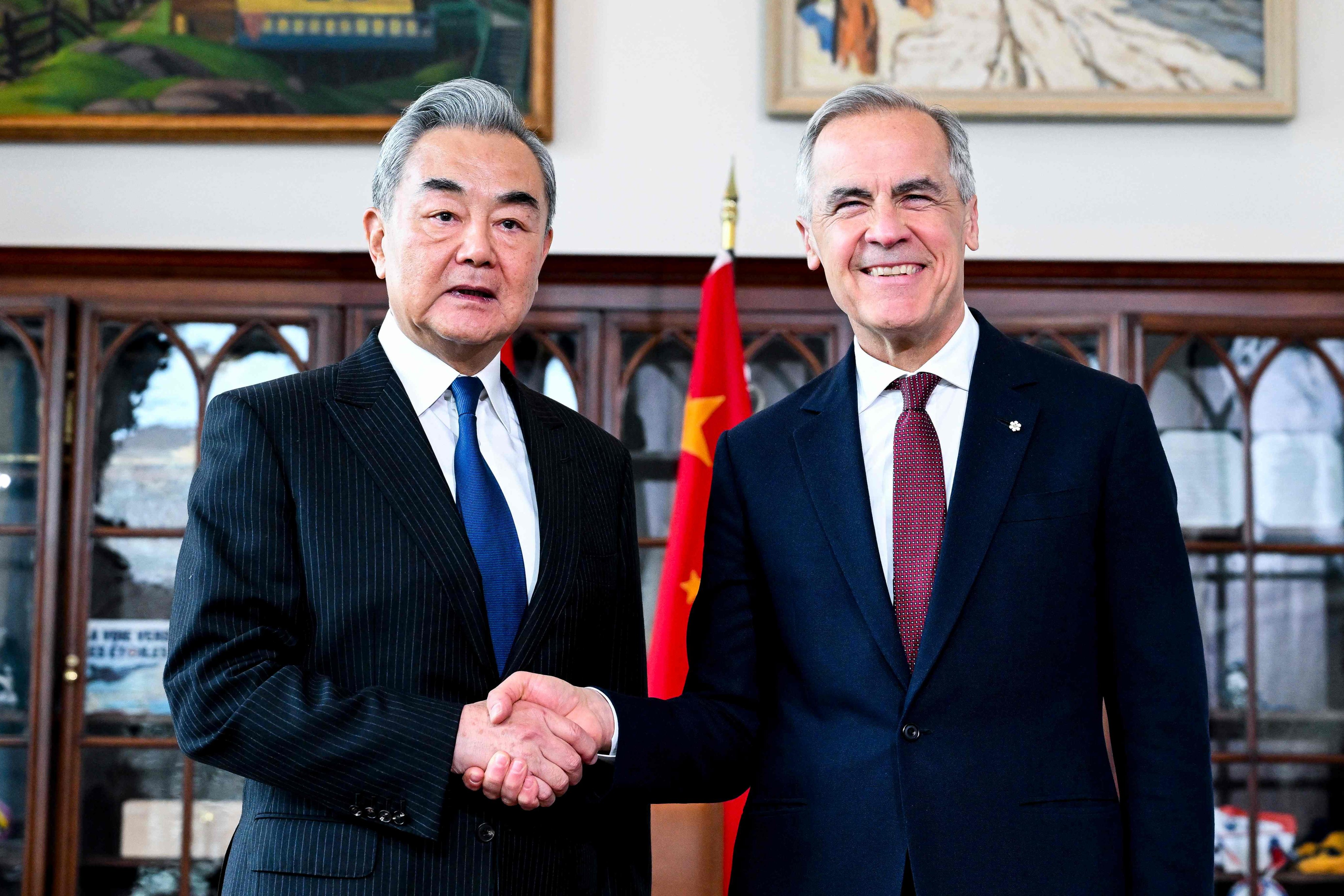 Canadian Prime Minister Mark Carney shakes hands with Chinese Foreign Minister Wang Yi in his office in Ottawa on Friday. Photo: AFP