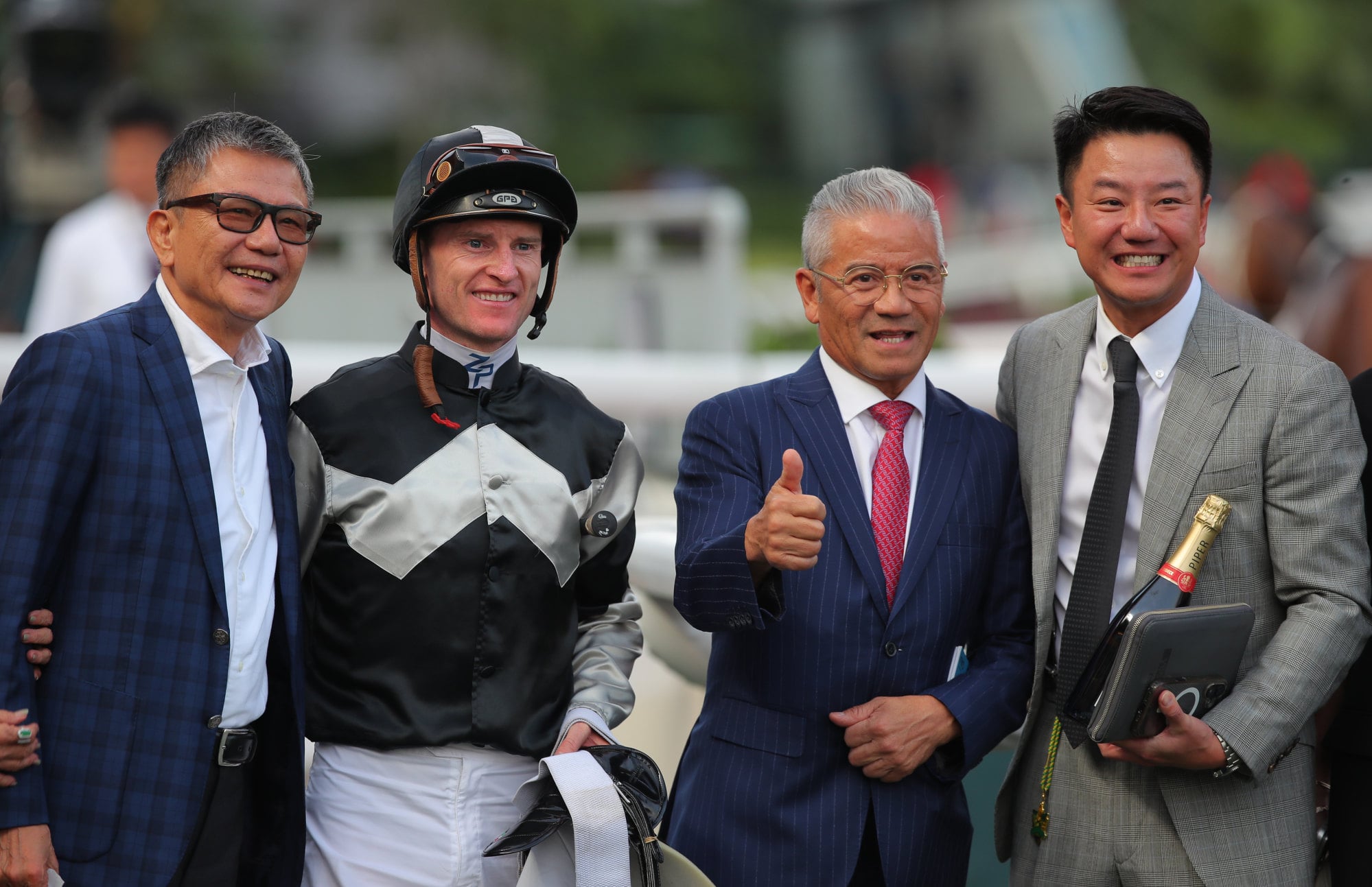 Jockey Zac Purton, trainer Tony Cruz (second from right) and connections of Winning Ovation celebrate his latest win. Jockey Zac Purton, trainer Tony Cruz (second from right) and connections of Winning Ovation celebrate his latest win.