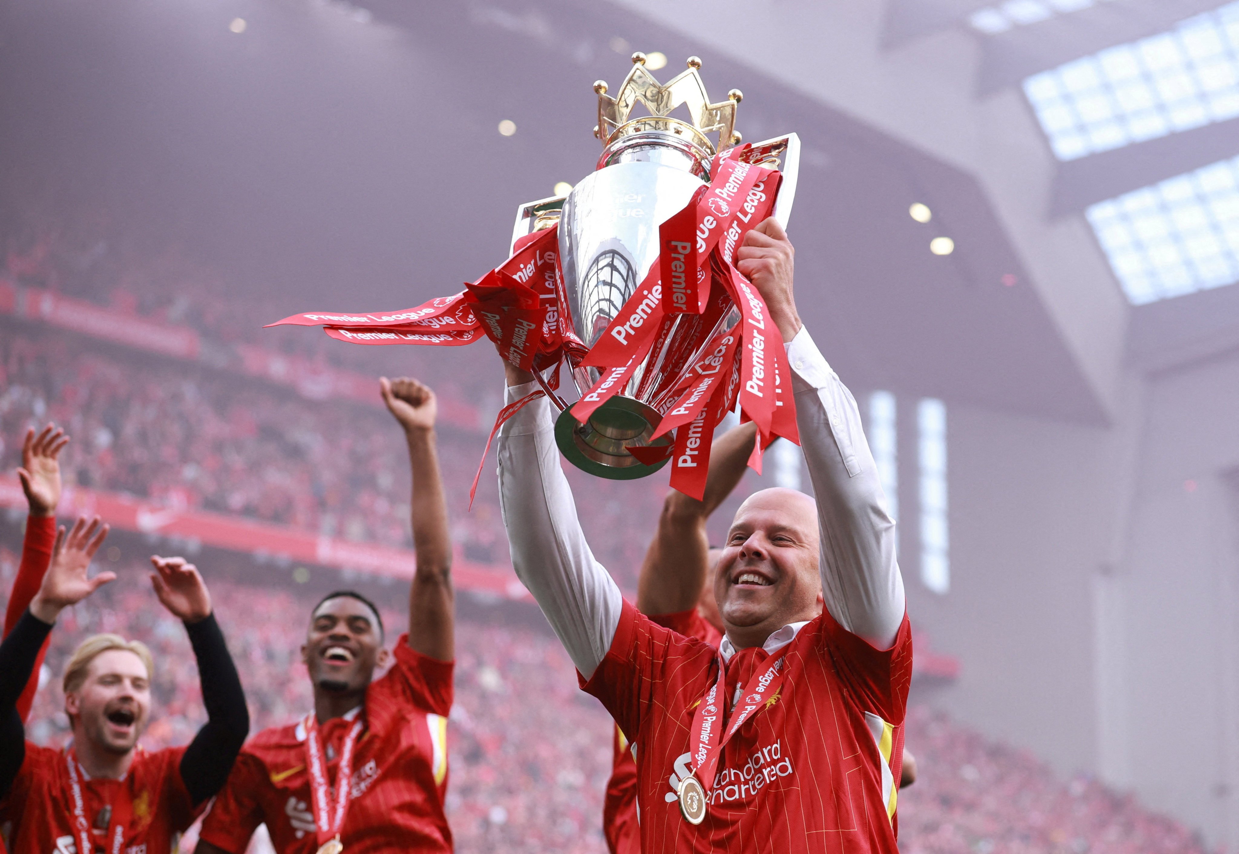 Liverpool manager Arne Slot celebrates with the trophy after winning the Premier League. Photo: Reuters