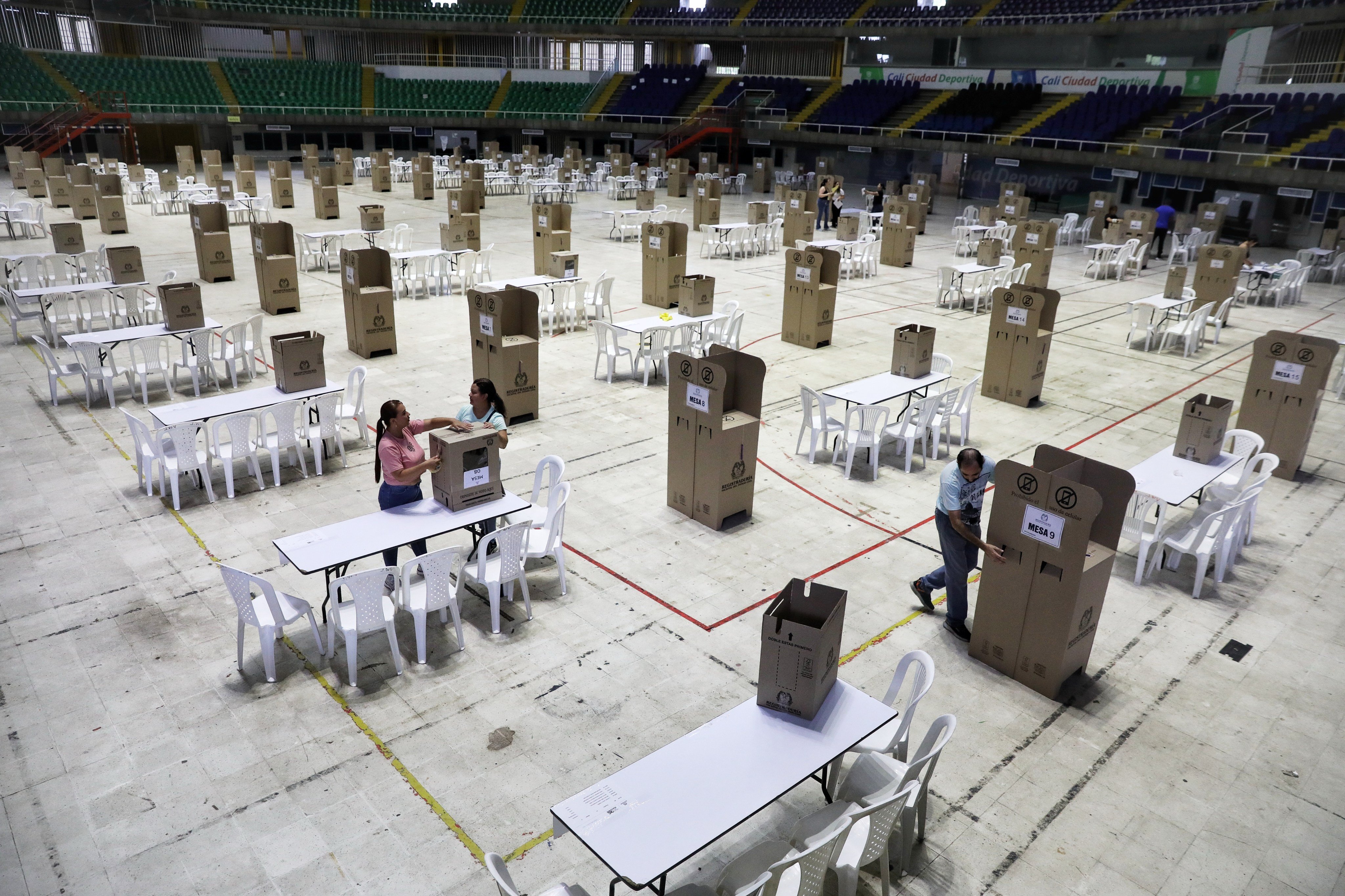 Electoral workers set up a voting center in preparation for Sunday’s presidential election in Cali, Colombia, on Saturday. Photo: AP