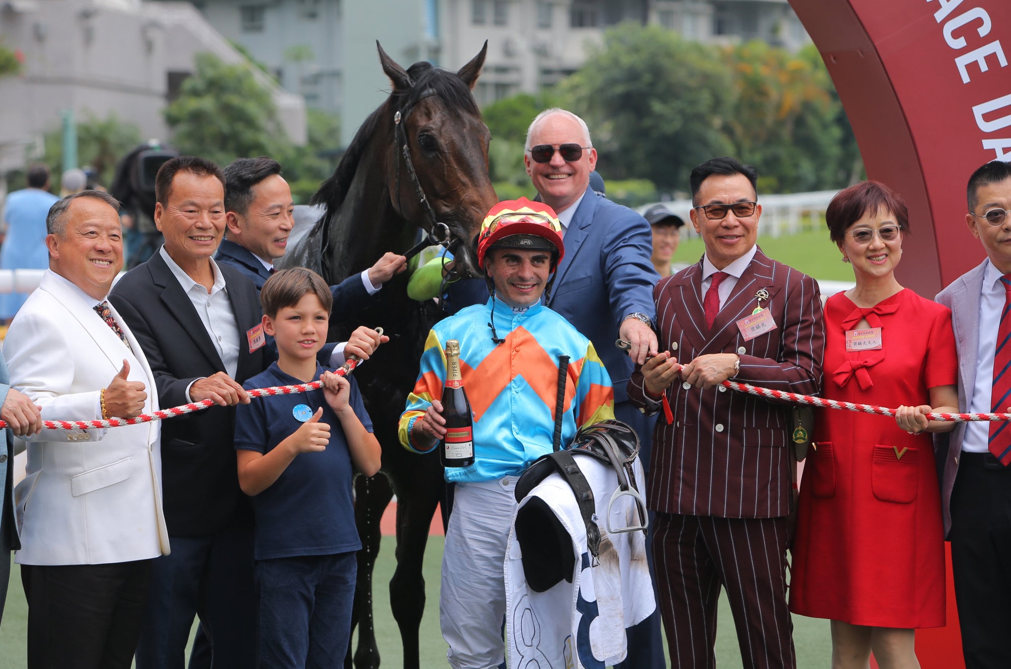 Connections of Ka Ying Lightning celebrate his debut victory. Connections of Ka Ying Lightning celebrate his debut victory.