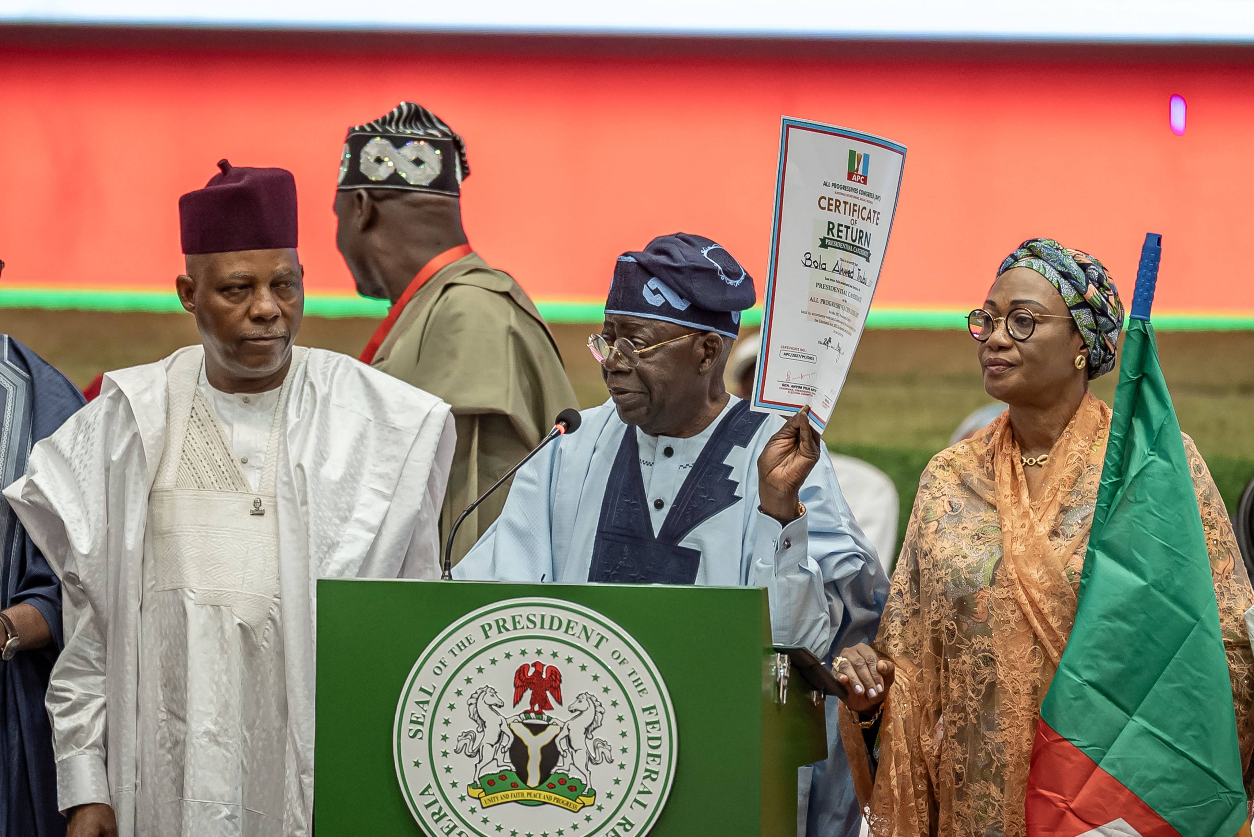 Nigeria’s President Bola Ahmed Tinubu (centre) displays his certificate of return as the flag bearer of his party after emerging victorious during the All Progressive Congress (APC) presidential primary election at the Bola Ahmed Tinubu International Conference Centre on May 24. Photo: AFP