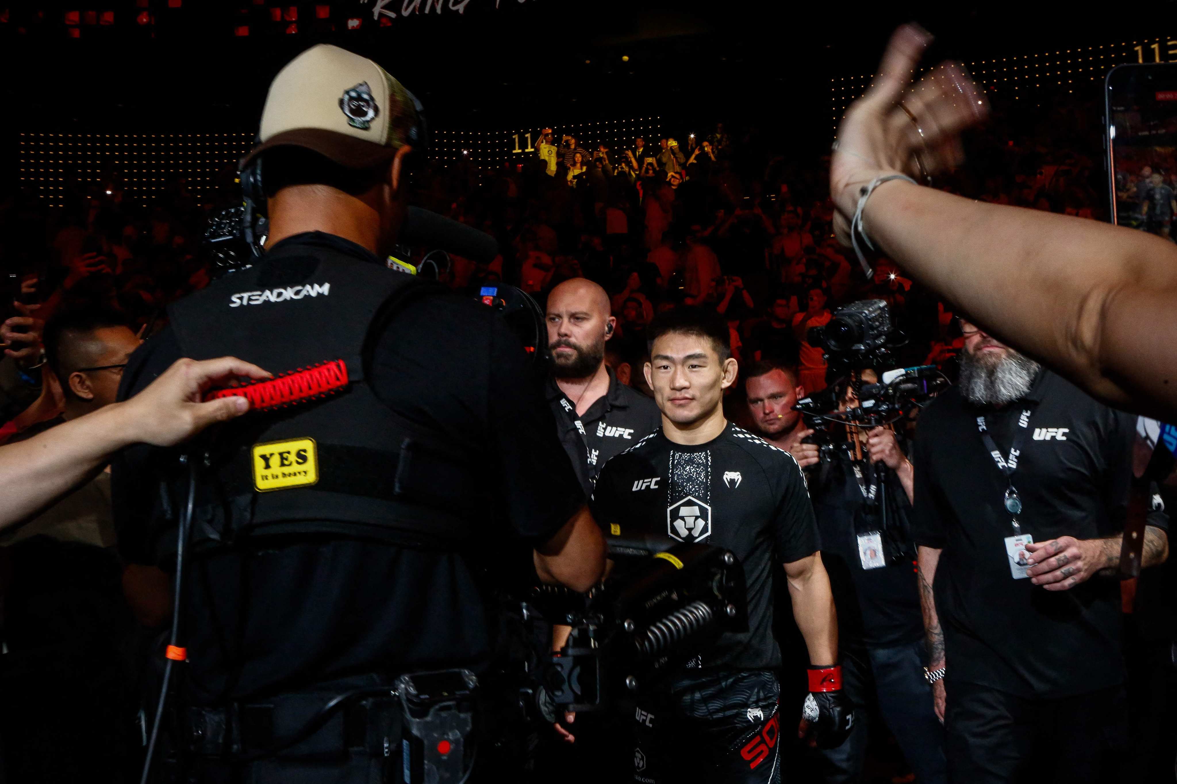 Chinas Song Yadong (centre) arriving for his bout against Brazils Deiveson Figueiredo during UFC Fight Night in Macau on Saturday. Photo: AFP