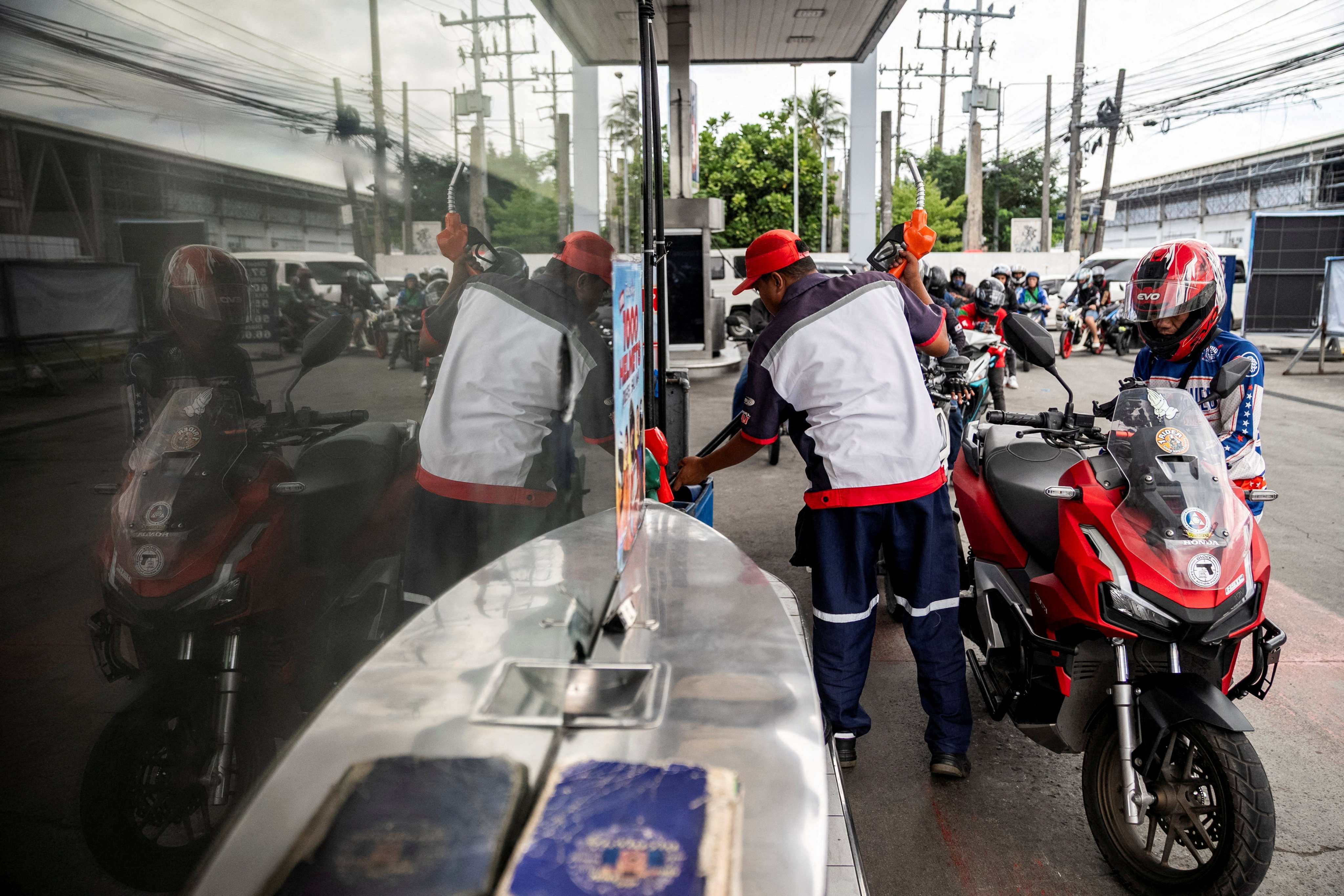 A worker fills up a motorcycle at a petrol station in Quezon City, Metro Manila, the Philippines, in March. Photo: Reuters