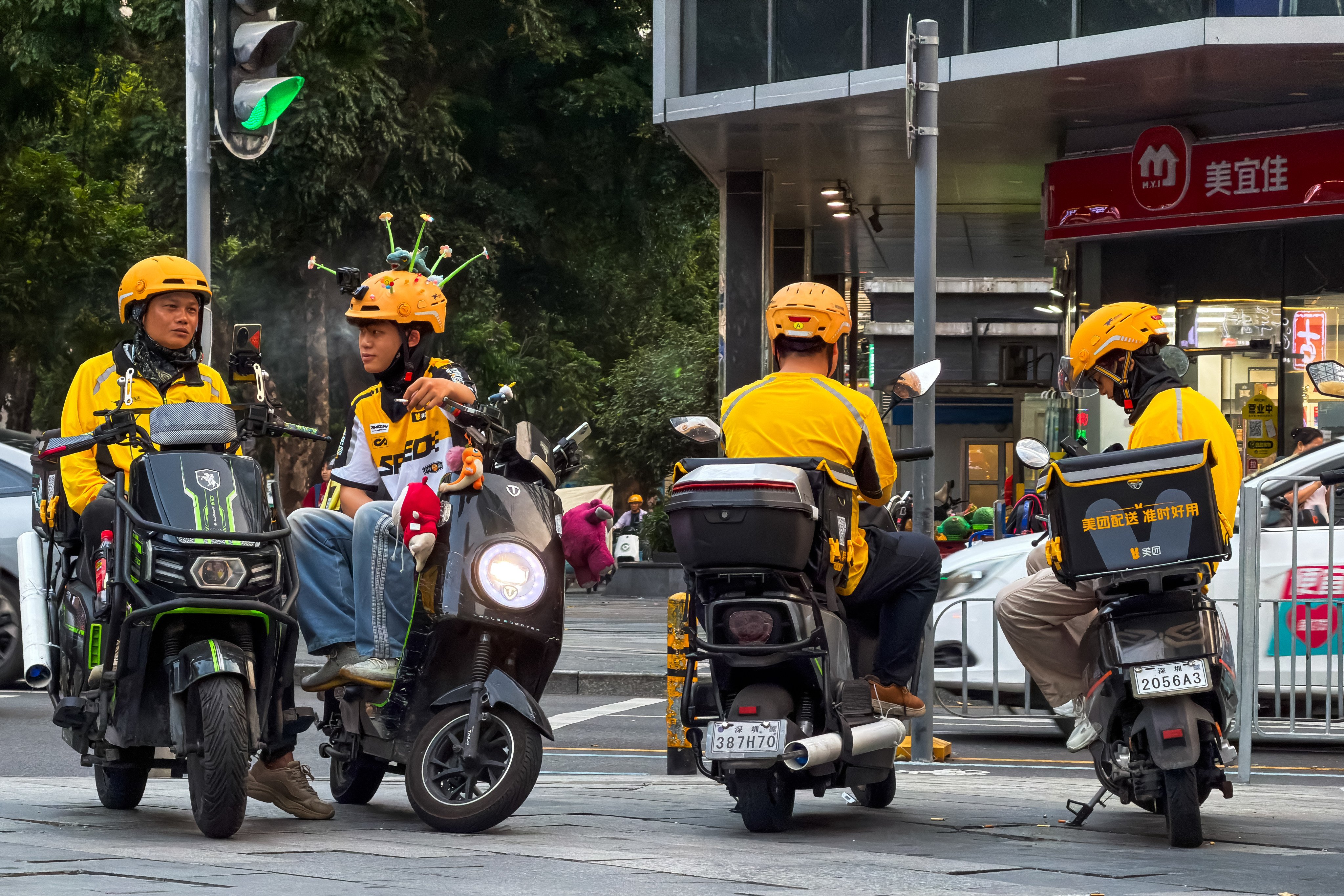 Meituan delivery riders wait for orders at an intersection in Shenzhen, March 24, 2026. Photo: Getty Images