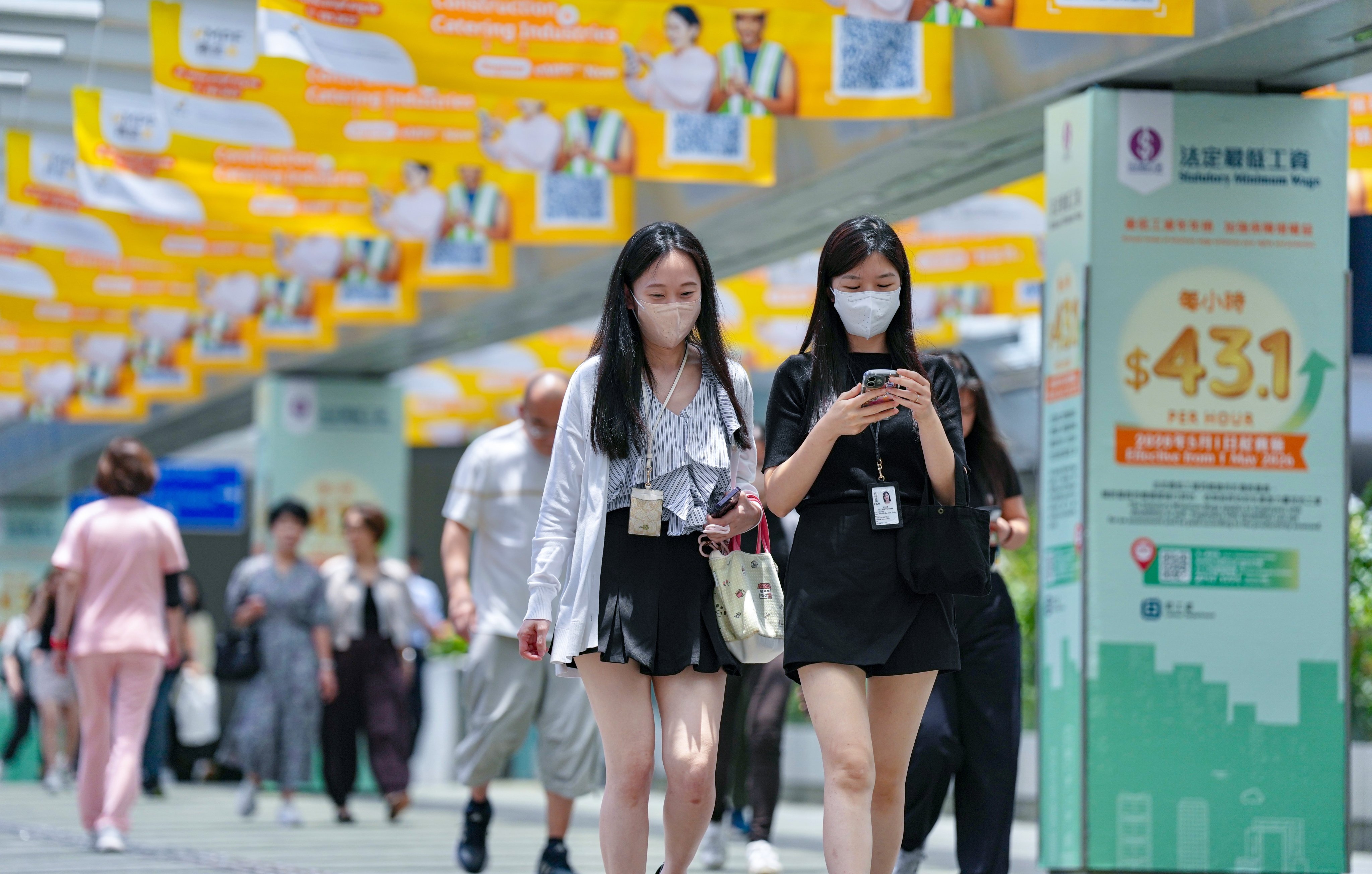 Civil servants step out of the Central Government Offices at lunchtime on May 28. Photo: Karma Lo