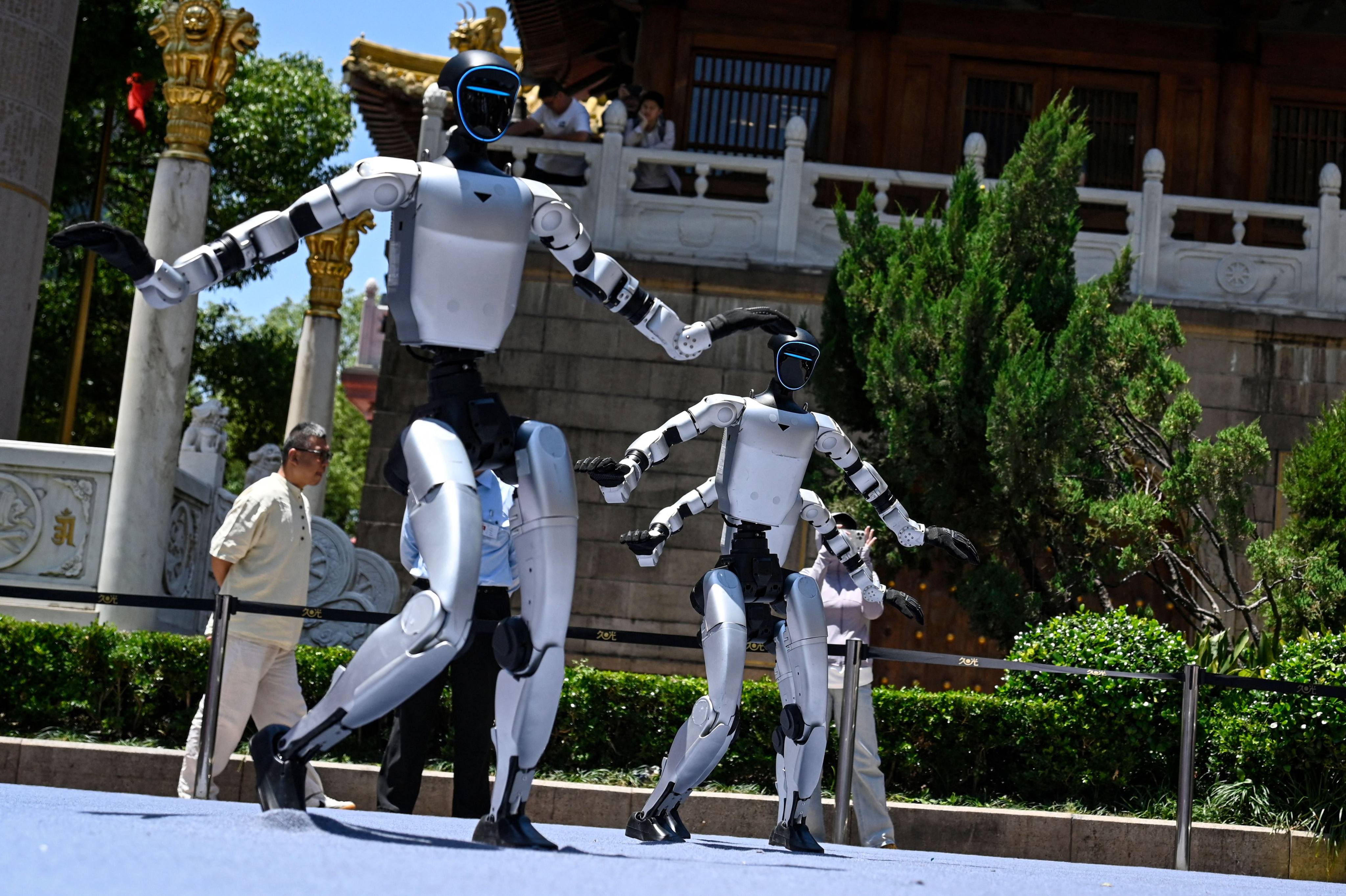 Humanoid robots manufactured by Unitree Robotics dance on the opening day of Asia’s first embodied intelligence experience store in Shanghai on Sunday. Photo: AFP