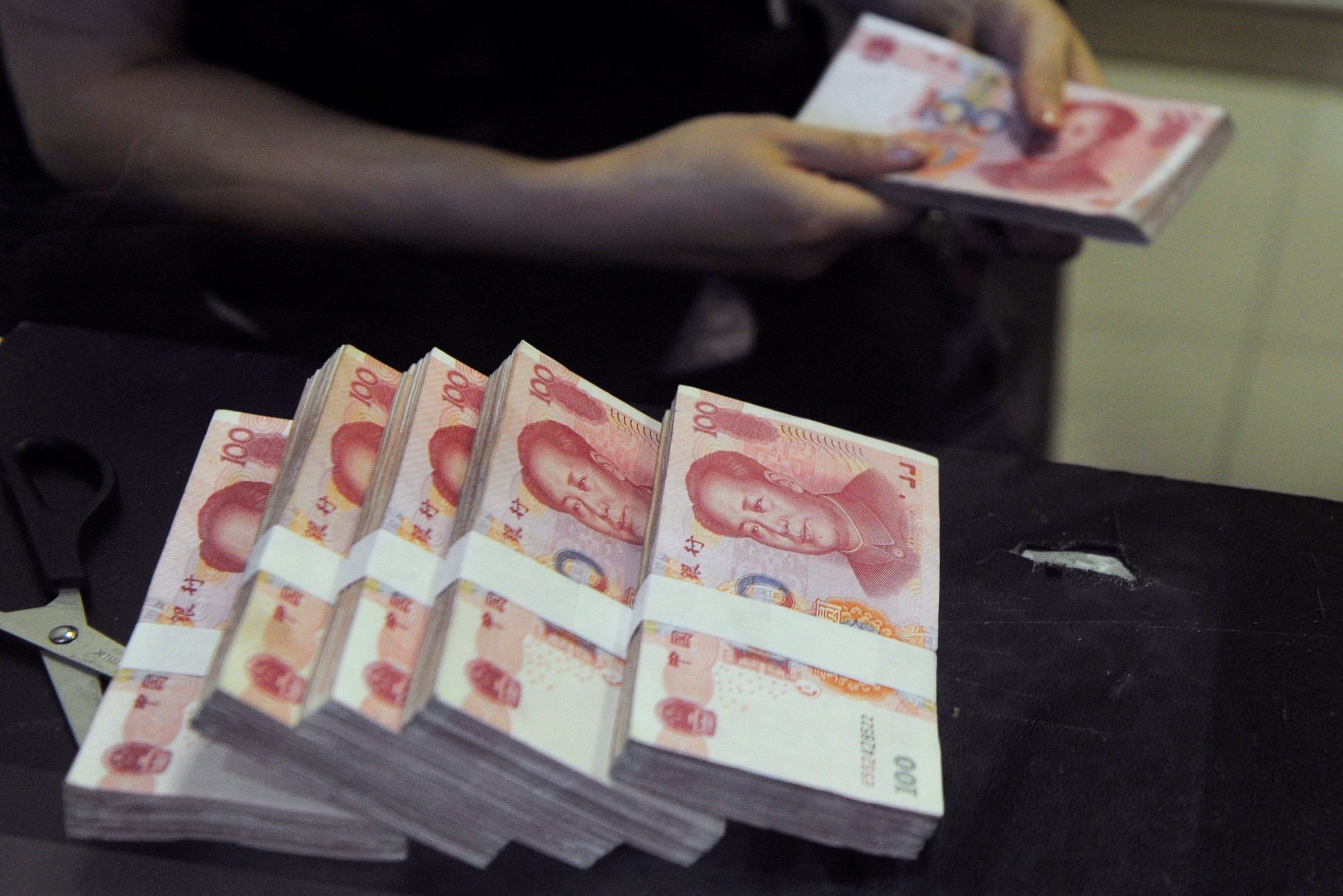 Chinese 100-yuan banknotes at a branch of China Merchants Bank in Hefei, Anhui province. Photo: Reuters