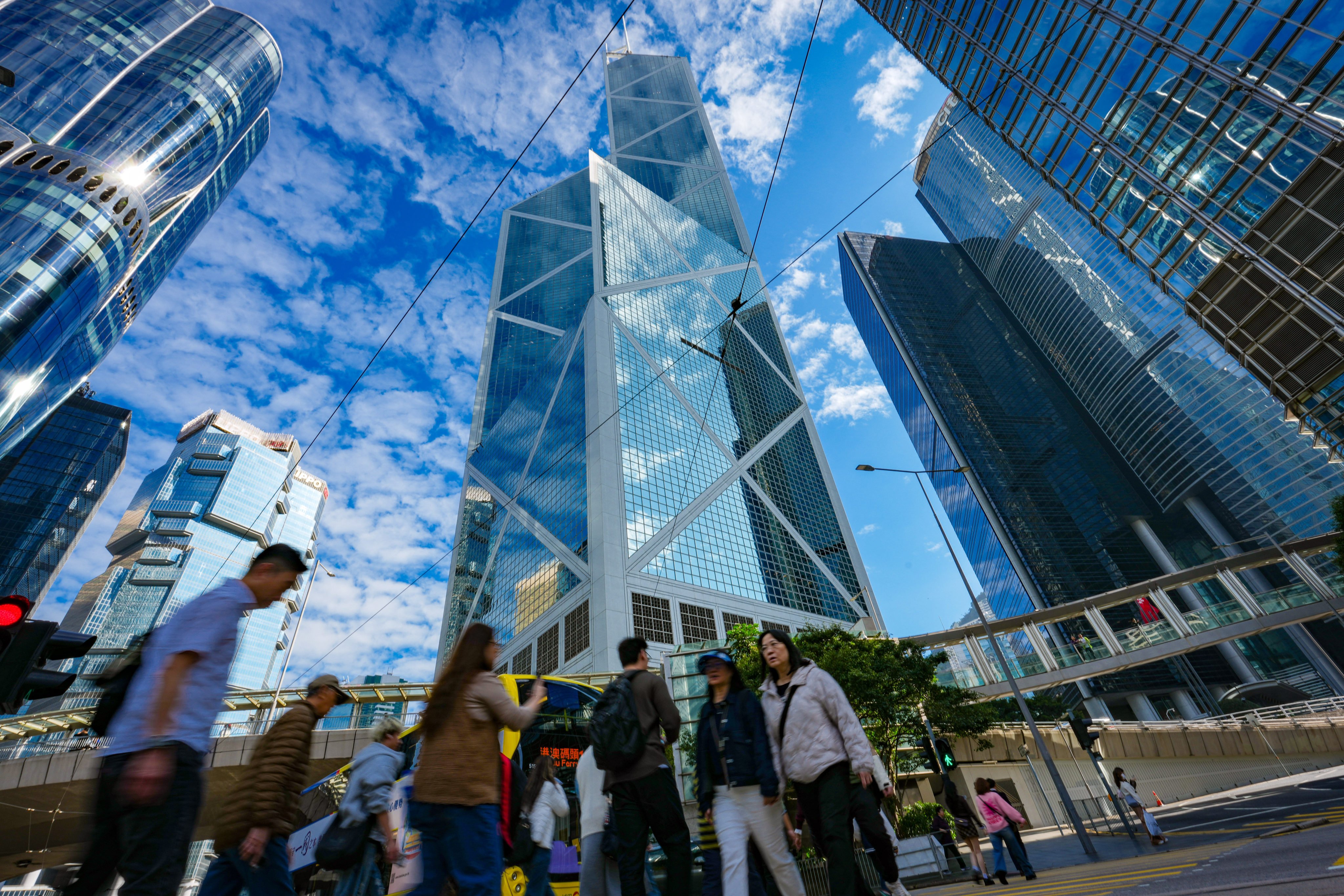 People walk amid office towers in Central on January 26. Average rents for grade A offices in the Central business district grew nearly 6 per cent on a quarterly basis last quarter, while rents for premium buildings in the district surged 12 per cent, the fastest rate since the third quarter of 2010. Photo: Jelly Tse