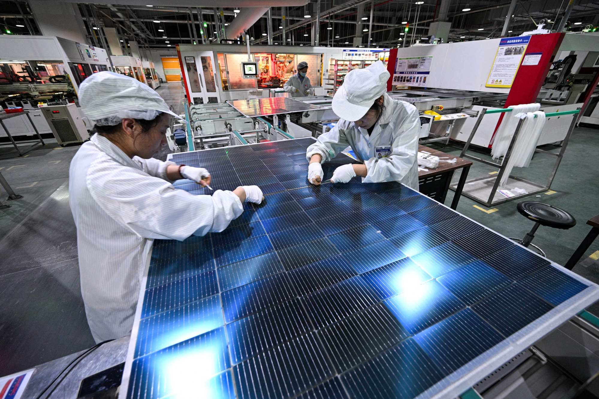 Workers producing photovoltaic modules for solar panels in a factory in China’s Jiangsu province. Photo: AFP