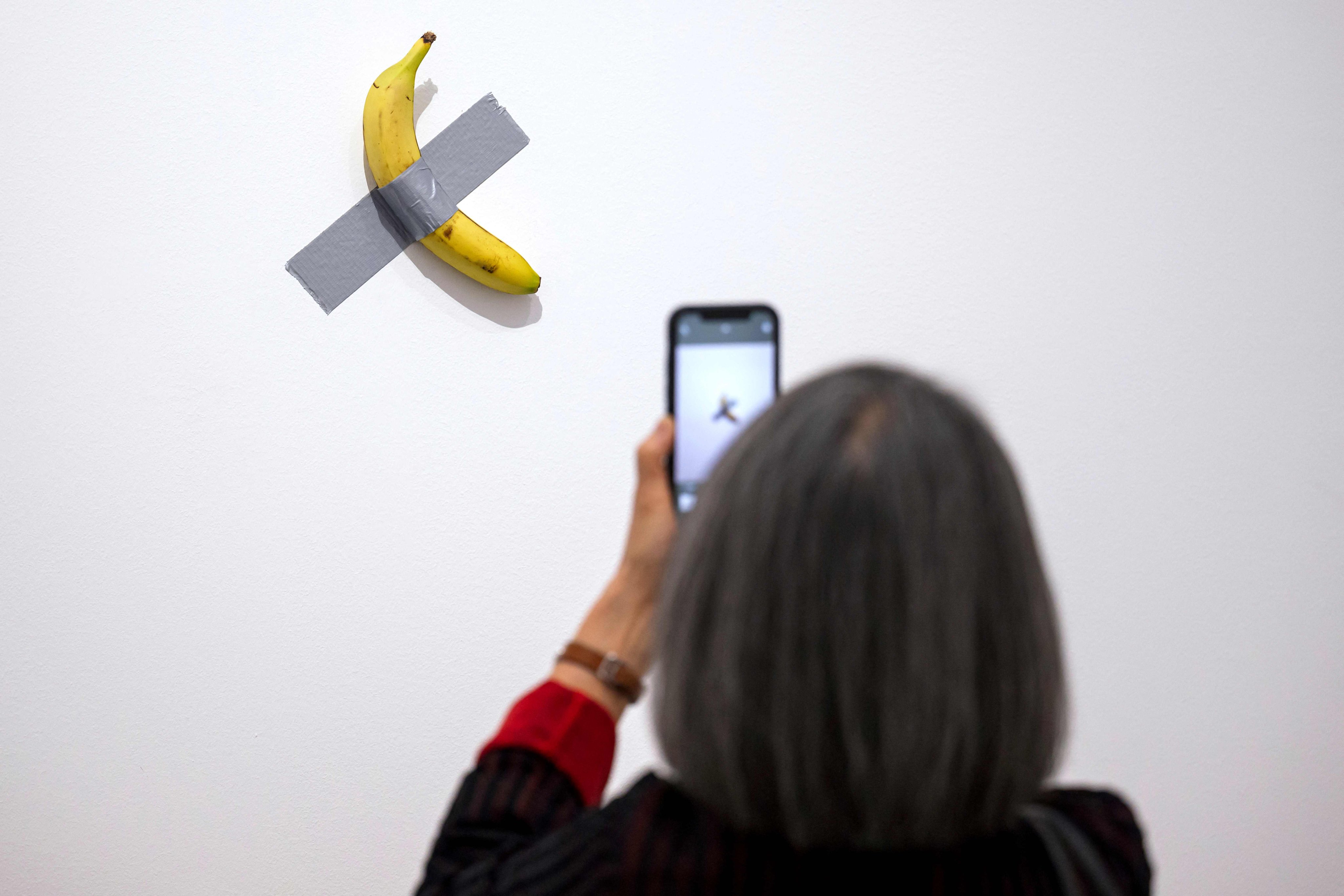 A visitor looks at the “Comedian” artwork by Italian artist Maurizio Cattelan at the Centre Pompidou-Metz in Metz in May last year. On Sunday, 2025. (Photo by Jean-Christophe VERHAEGEN / AFP) / RESTRICTED TO EDITORIAL USE - MANDATORY MENTION OF THE ARTIST UPON PUBLICATION - TO ILLUSTRATE THE EVENT AS SPECIFIED IN THE CAPTION