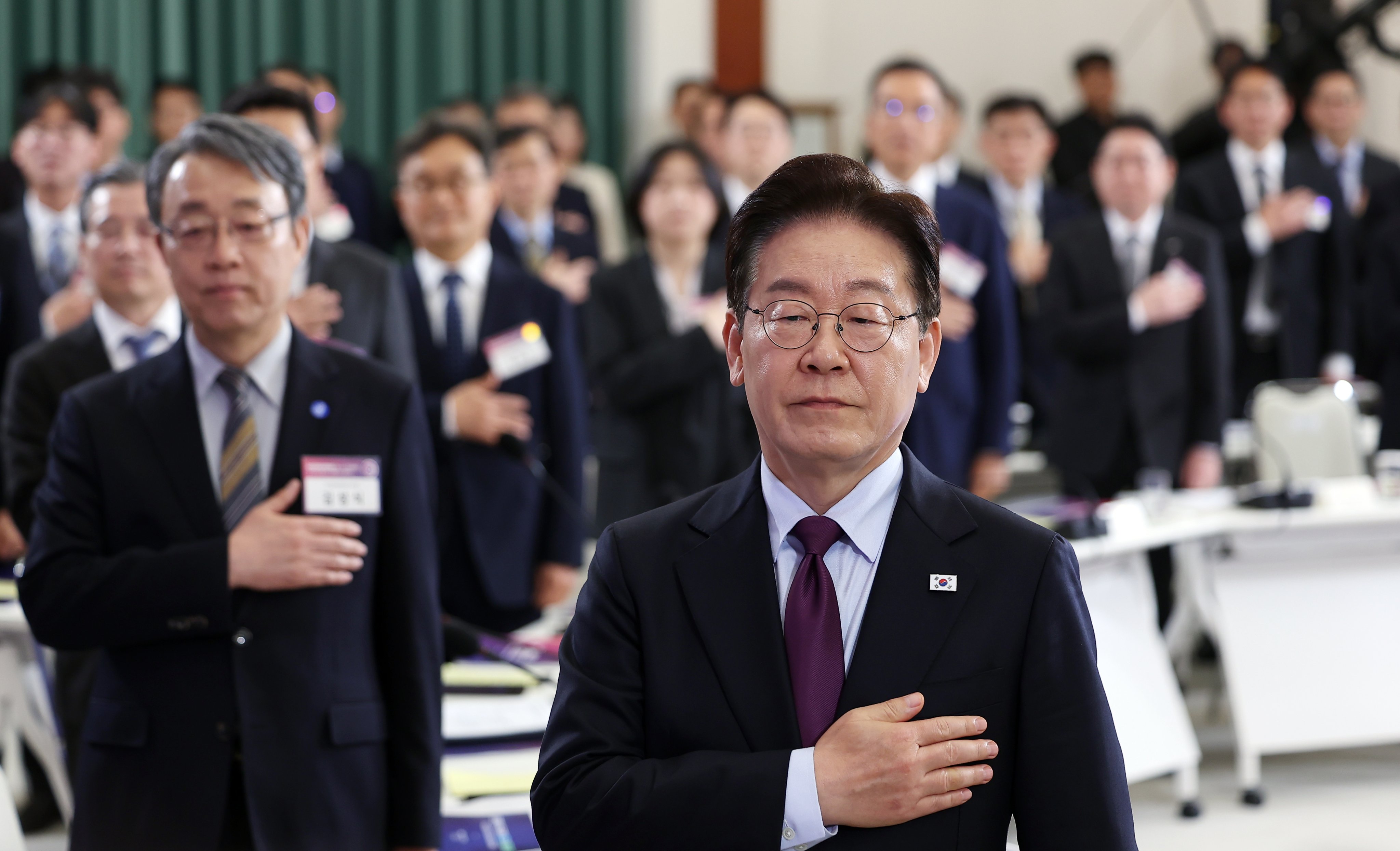 South Korean President Lee Jae Myung salutes the national flag at the first plenary meeting of the National Economic Advisory Council, at the presidential office in Seoul, South Korea, on April 9. Photo: EPA/Yonhap