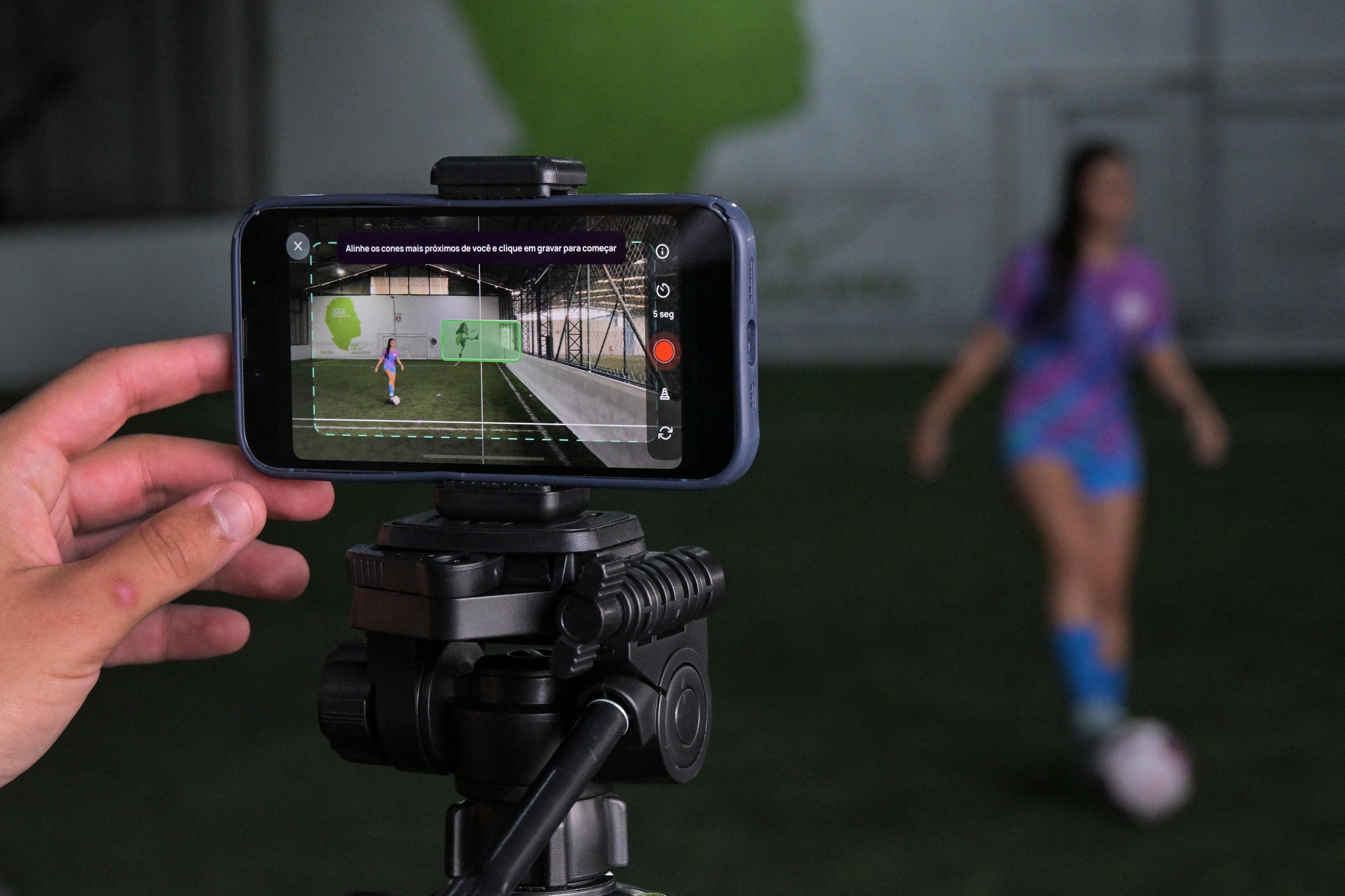 Brazilian footballer Marcela Geremias de Lima controls the ball while being recorded for the Cuju app in Sao Paulo. Photo: AFP