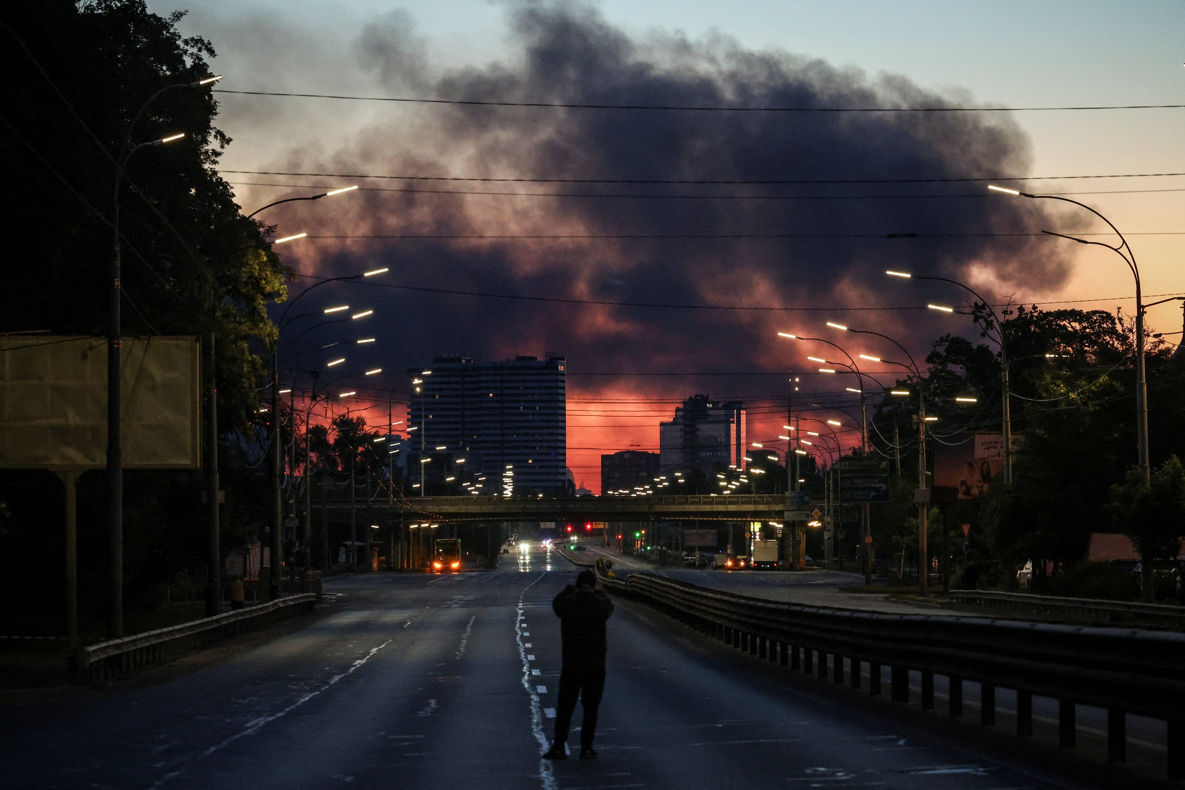 A man takes a picture of a Kyiv street. Photo: Reuters