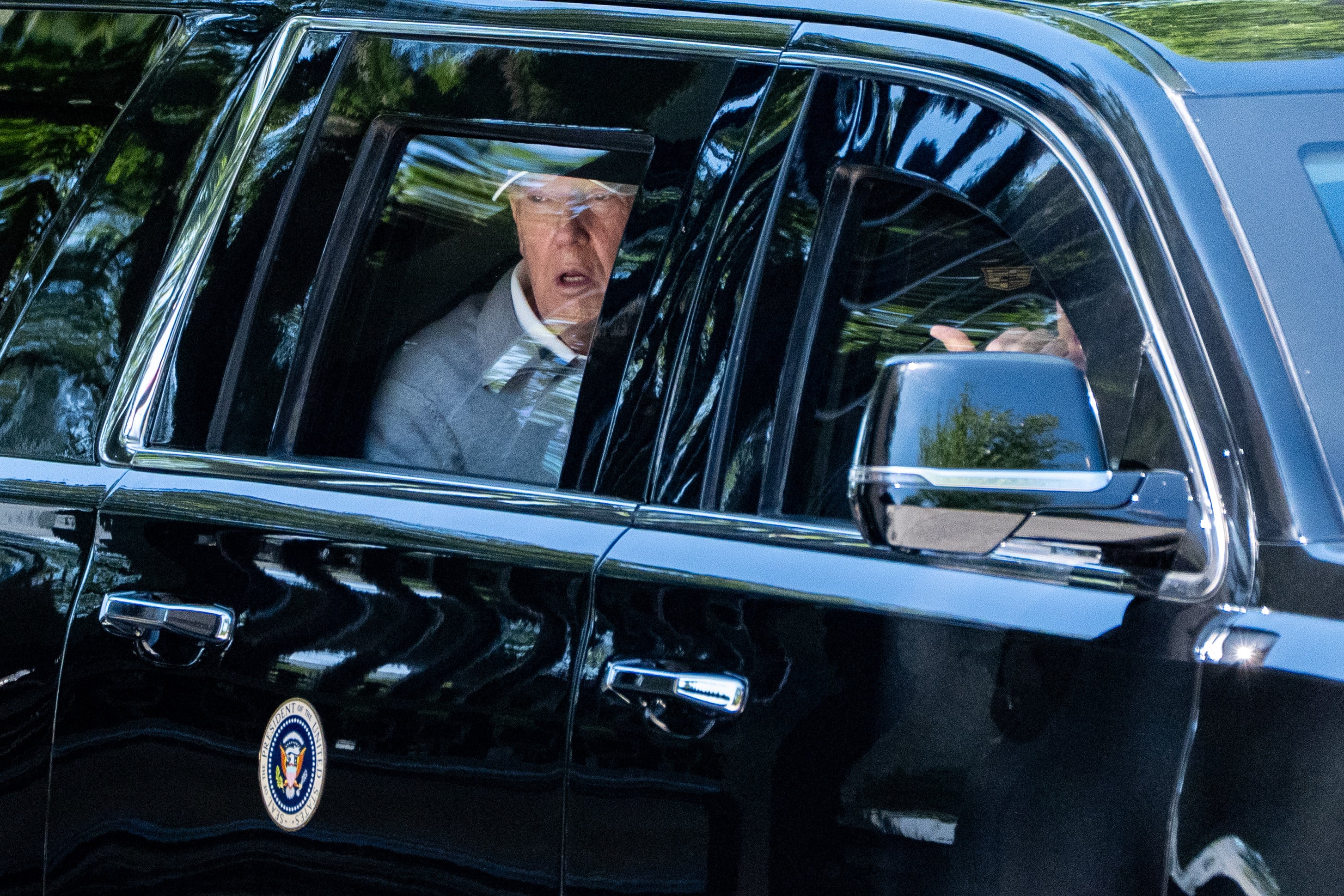 US President Donald Trump looks out the window of his limousine. Photo: AP