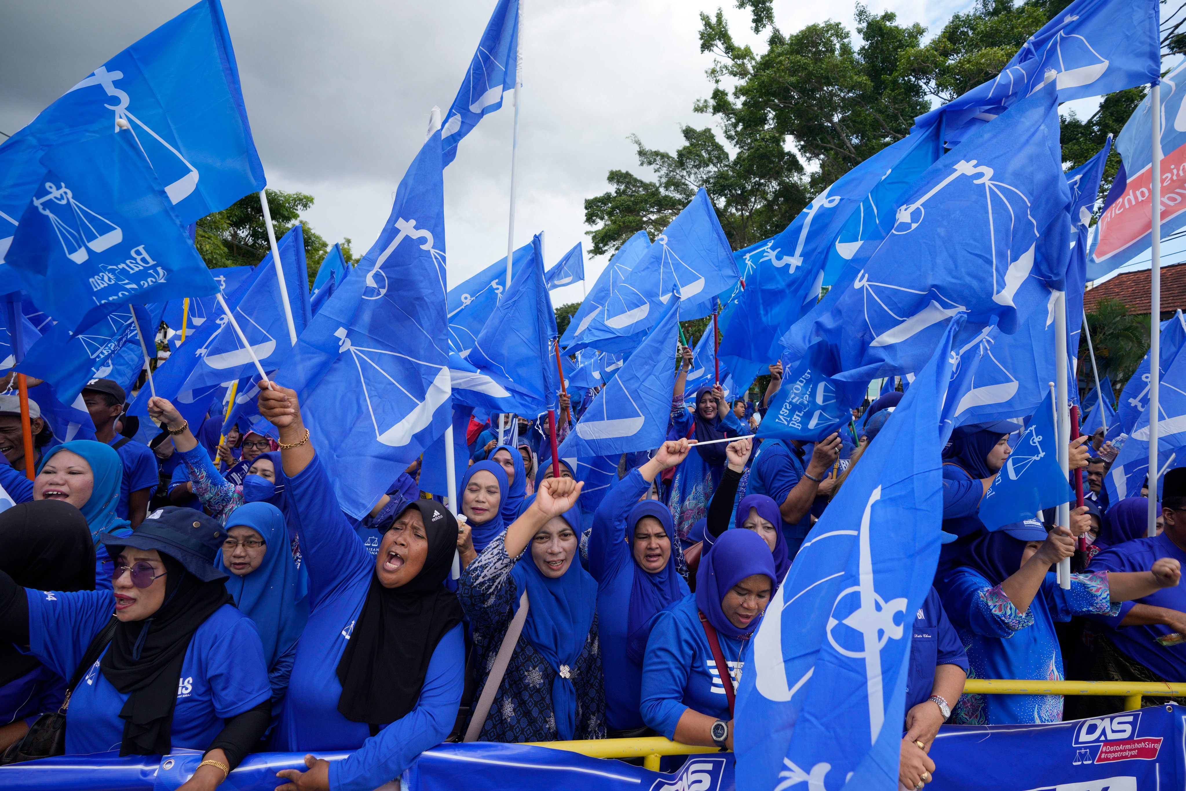 Supporters of Malaysia’s Barisan National coalition led by Umno, wave flags outside the nomination centre in Langkawi Island in November 2022. Photo: AP