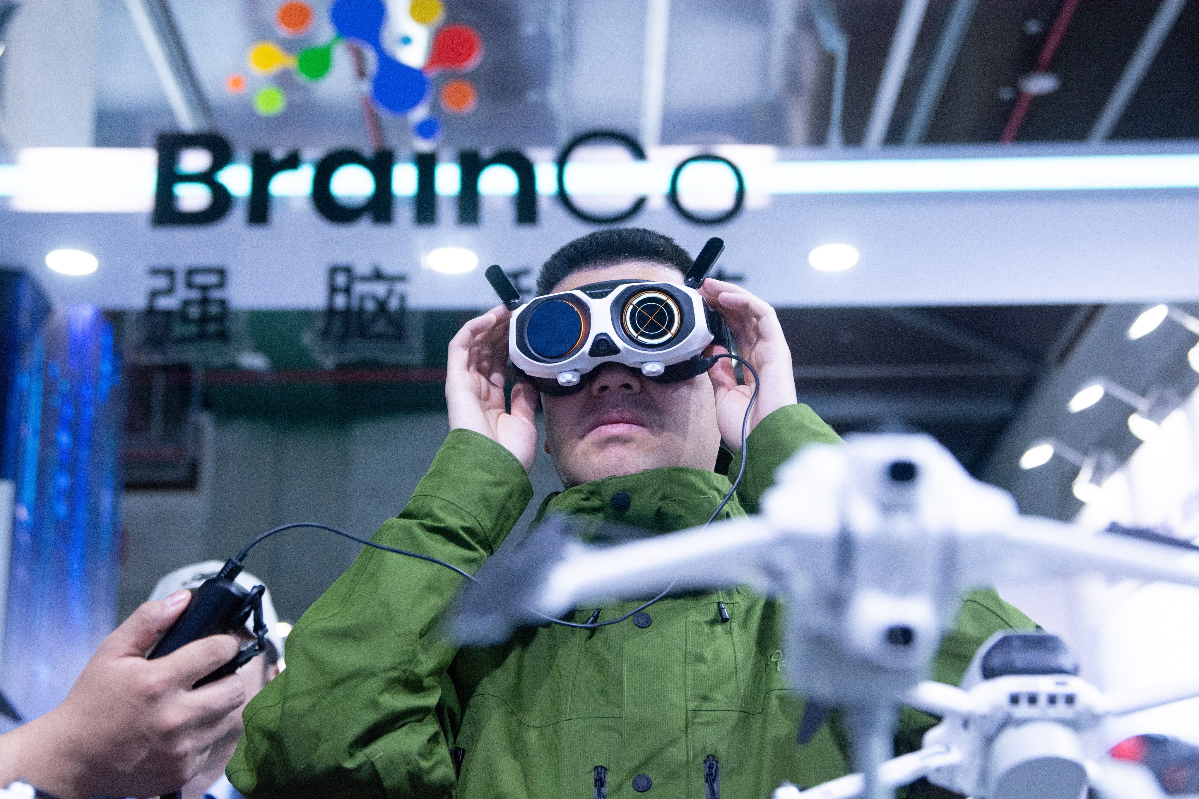 A visitor watches video from a drone at the AWE trade fair in the Shanghai Eastern Hub International Business Cooperation Zone on March 14. Photo: NurPhoto via Getty Images