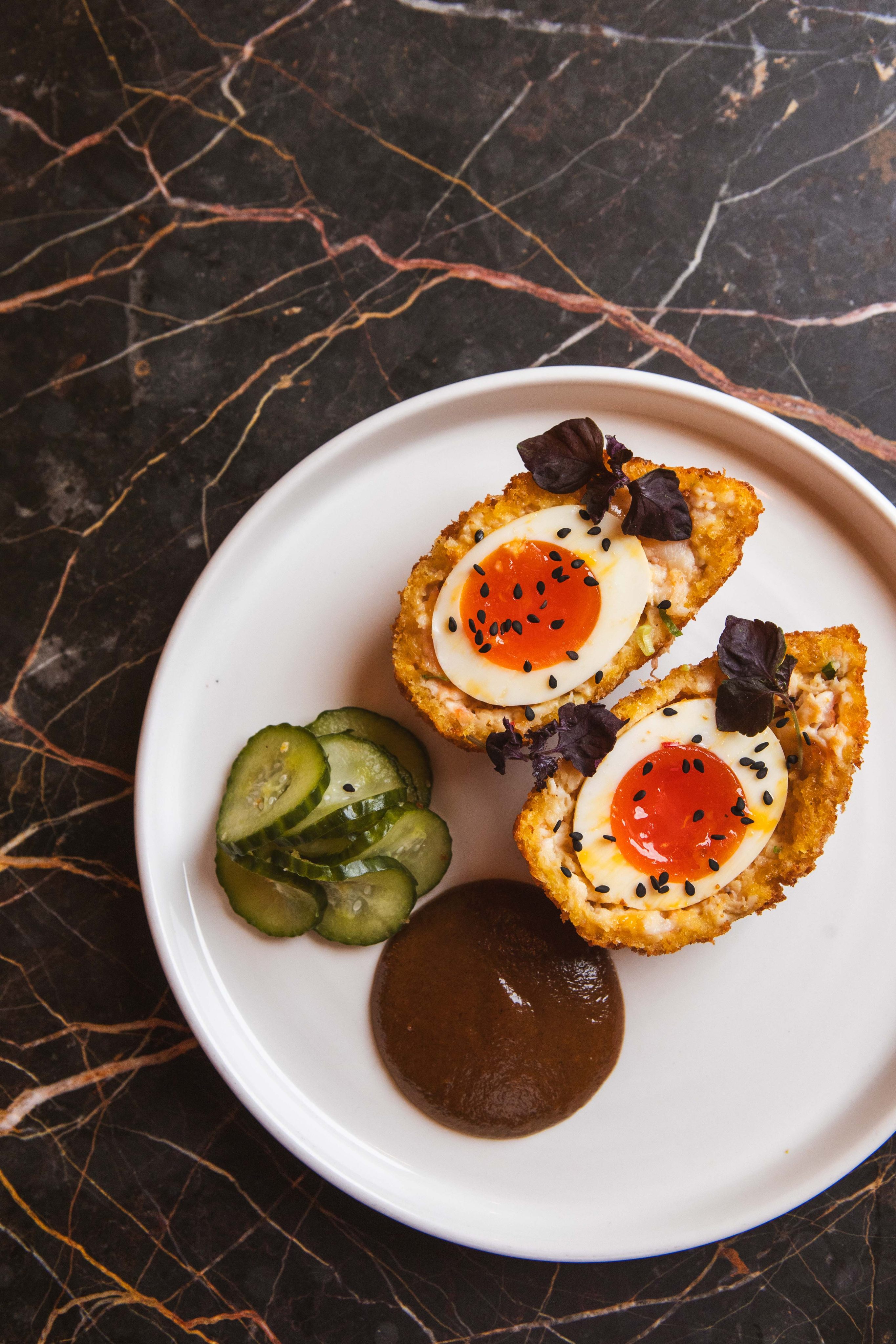 The prawn toast scotch egg at Jikoni is a coming together of Cantonese, British and Southeast Asian influences. Photo: Laura Jalbert