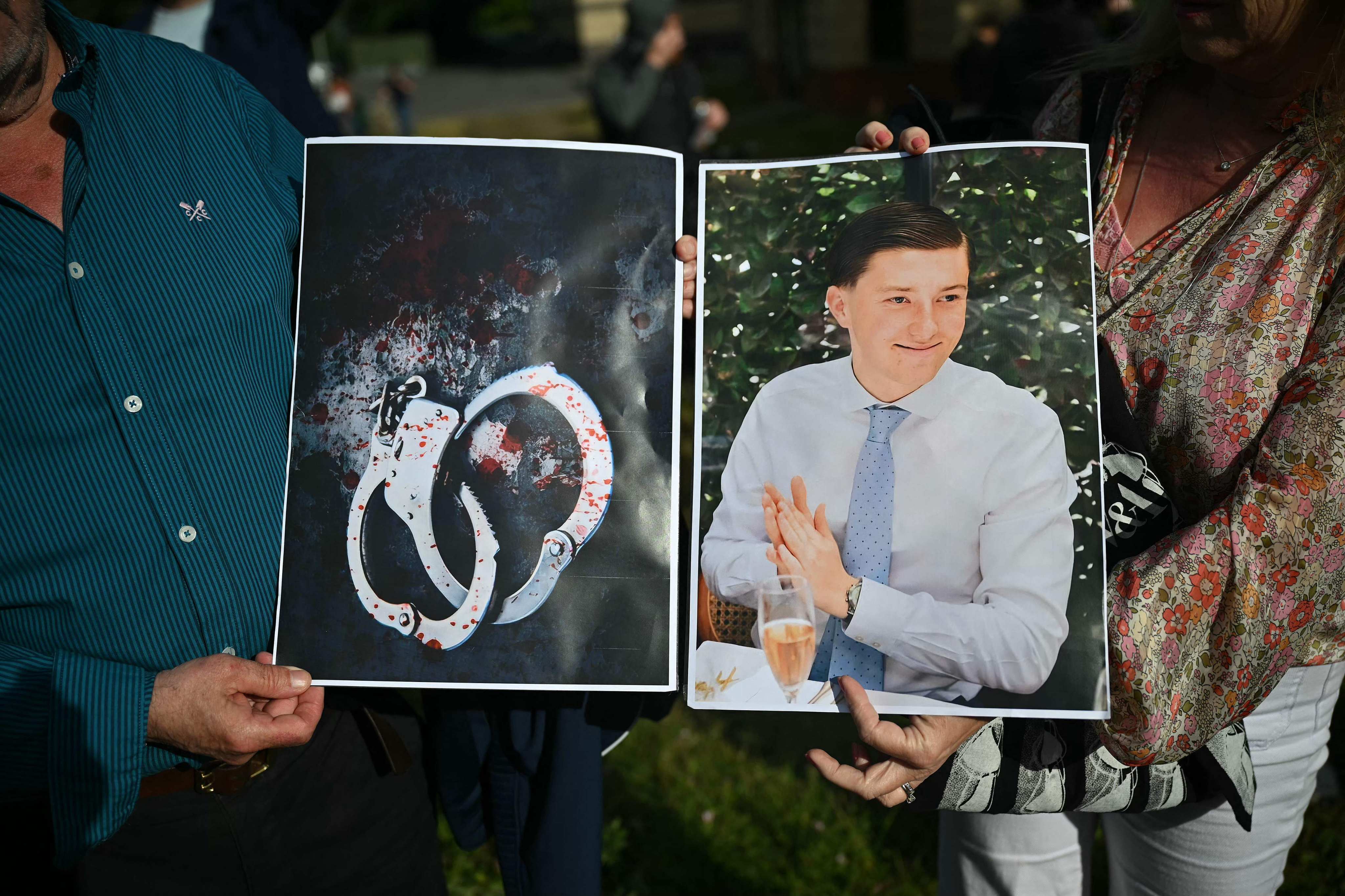 People hold images of victim Henry Nowak as they take part in a protest in Southampton on Tuesday following the murder of Nowak by Vickrum Digwa. Photo: AFP
