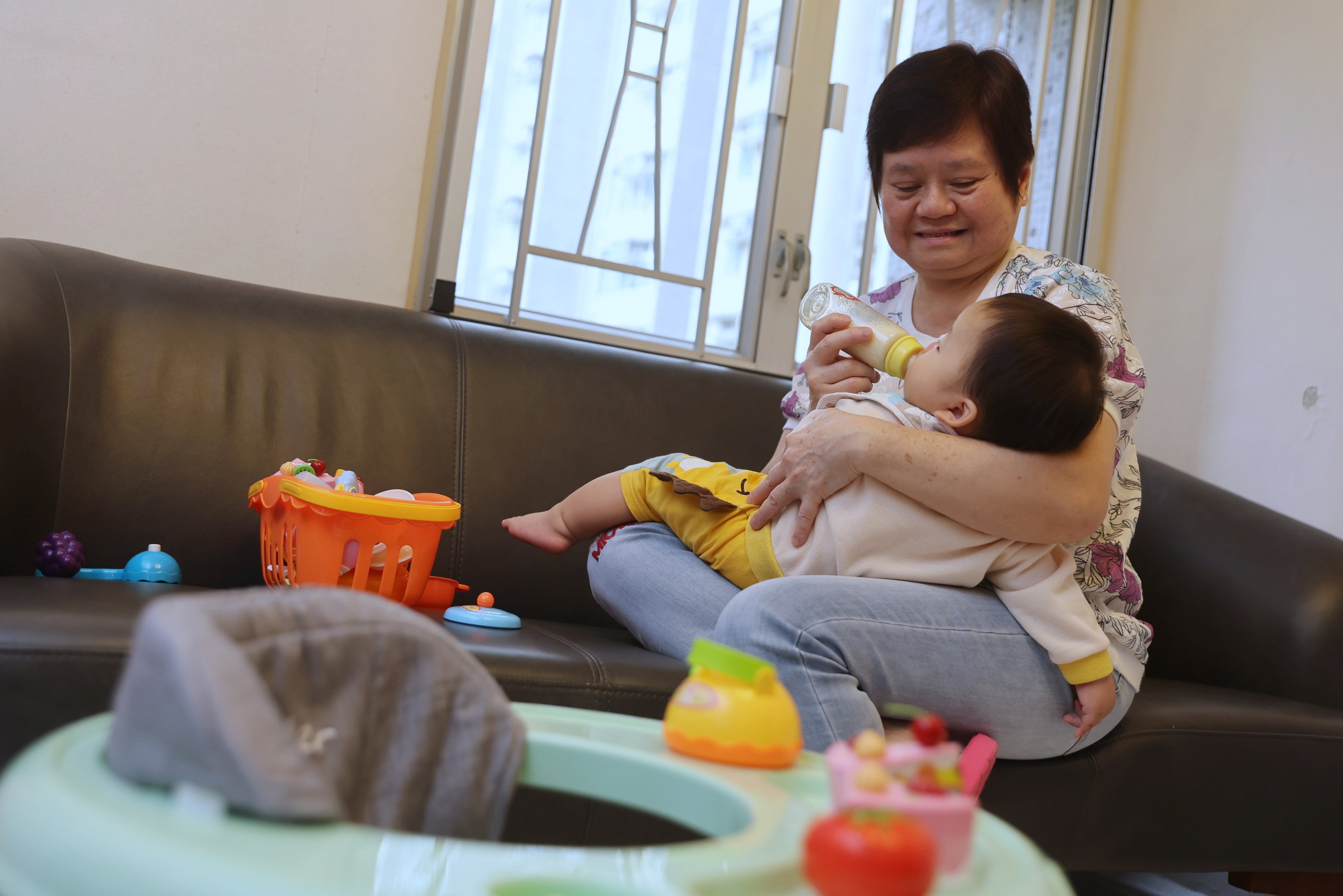 Lin Lai looks after baby Lok Lok in Sha Tin on September 25, 2025. In the past 13 years, Lai has been an emergency foster parent for more than 20 children. Photo: Edmond So